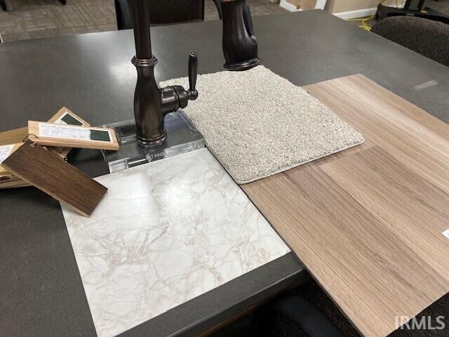 Kitchen view of a sink and light countertops
