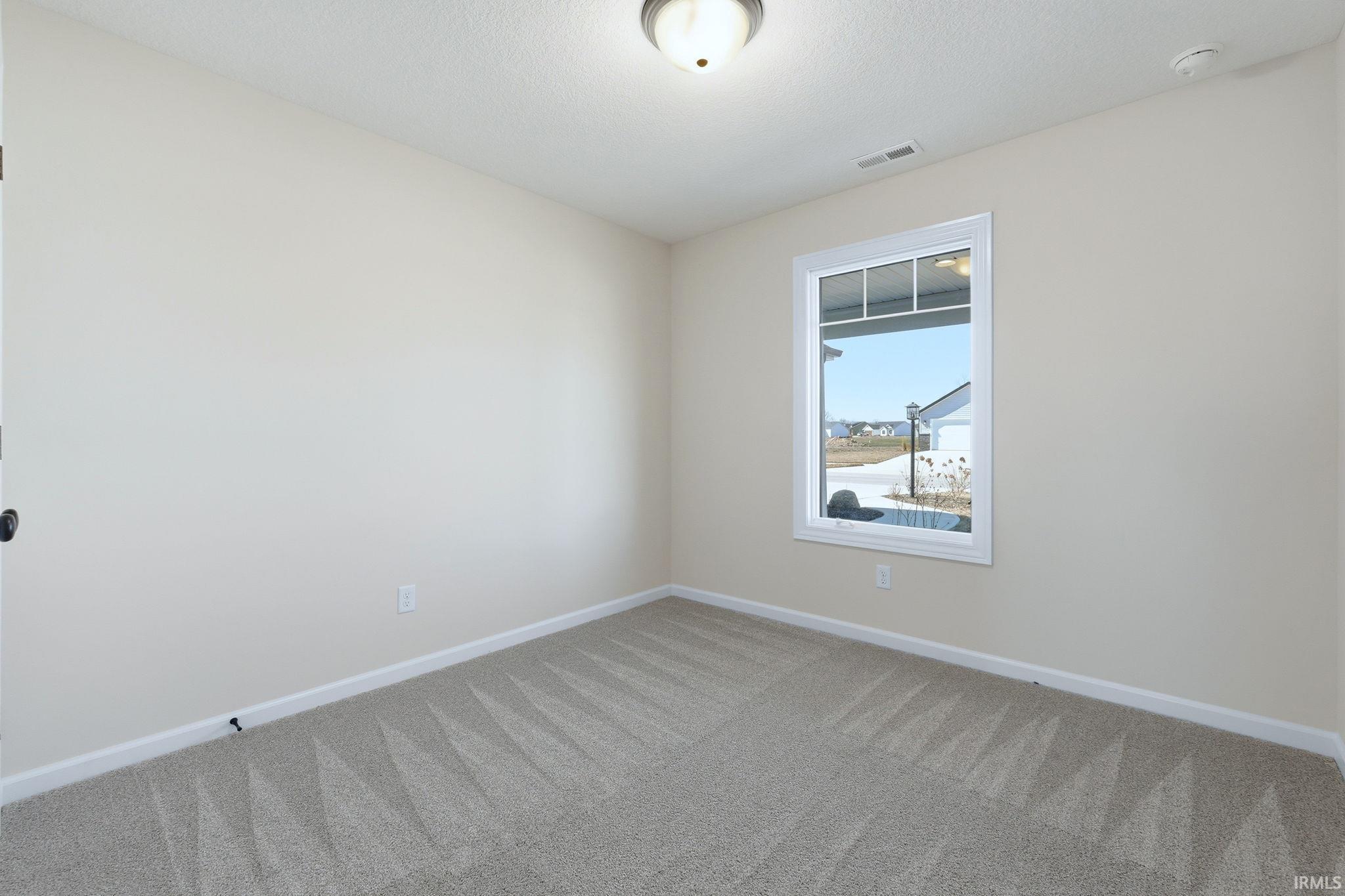 Unfurnished room featuring baseboards and light colored carpet