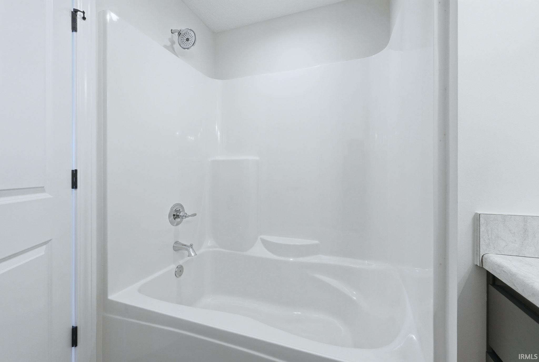 Full bath with vanity and shower / washtub combination