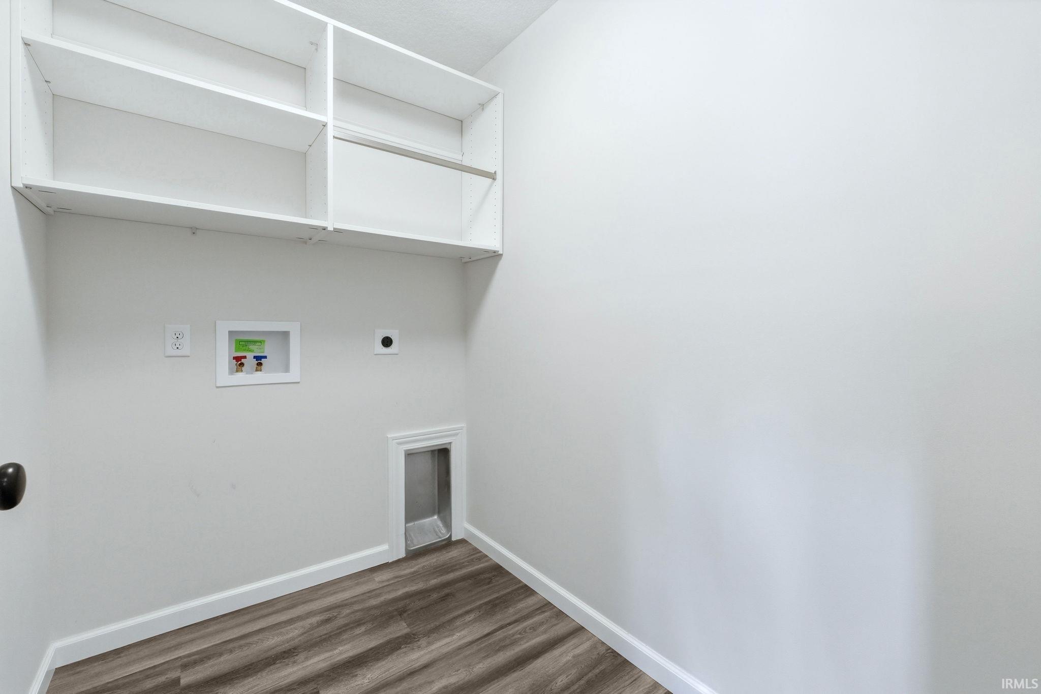 Laundry room with hookup for a washing machine, electric dryer hookup, and dark wood-style floors