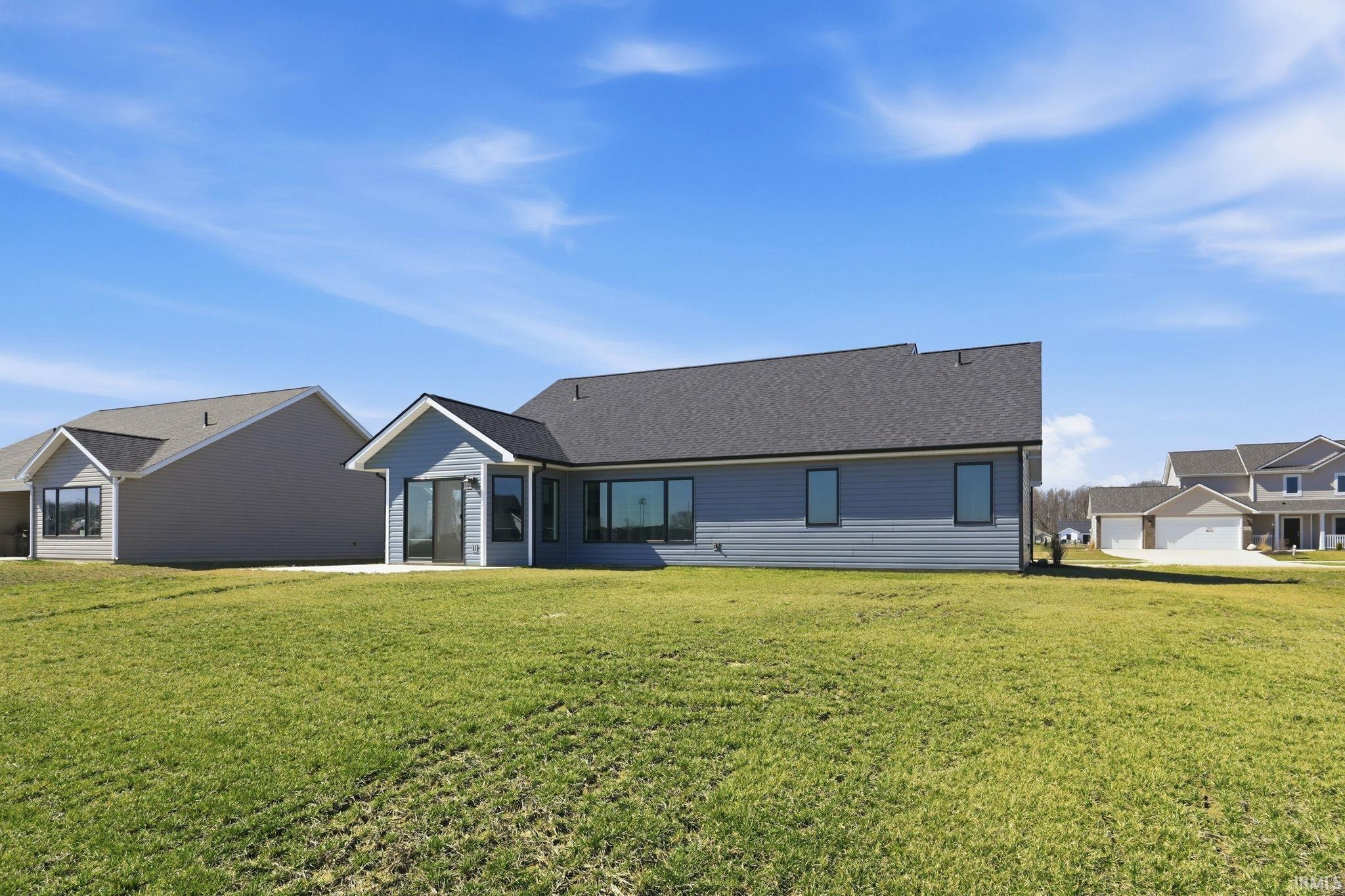 Rear view of property featuring a lawn