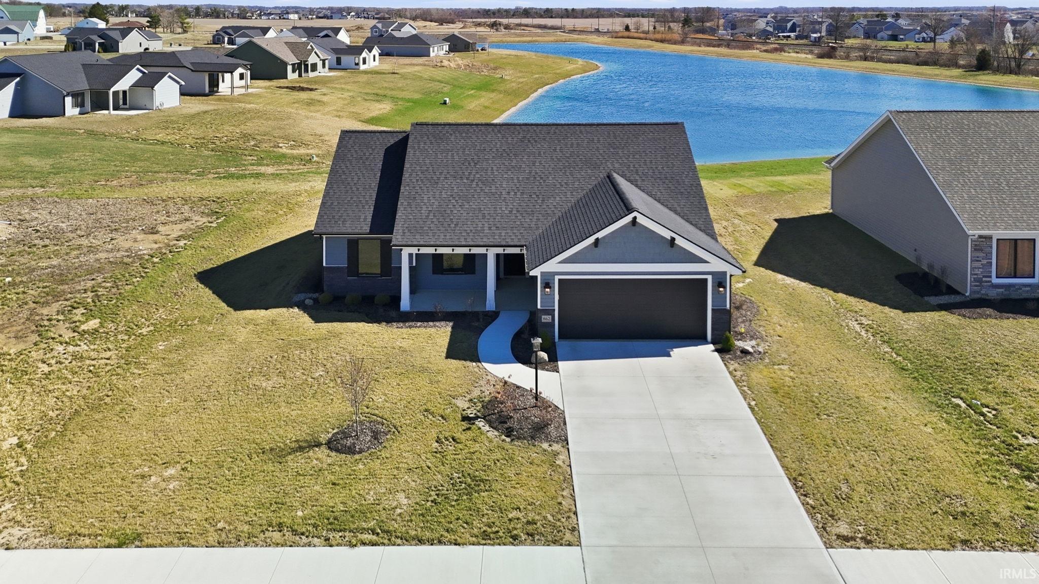 Aerial perspective of suburban area with a large body of water