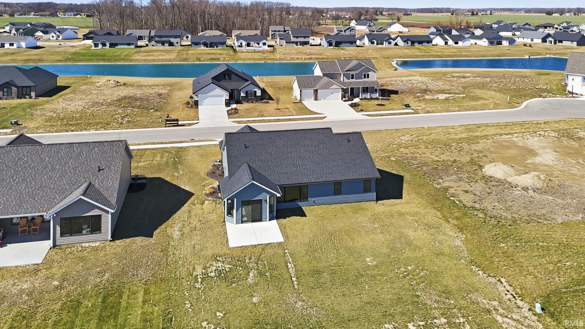 Aerial perspective of suburban area featuring a large body of water
