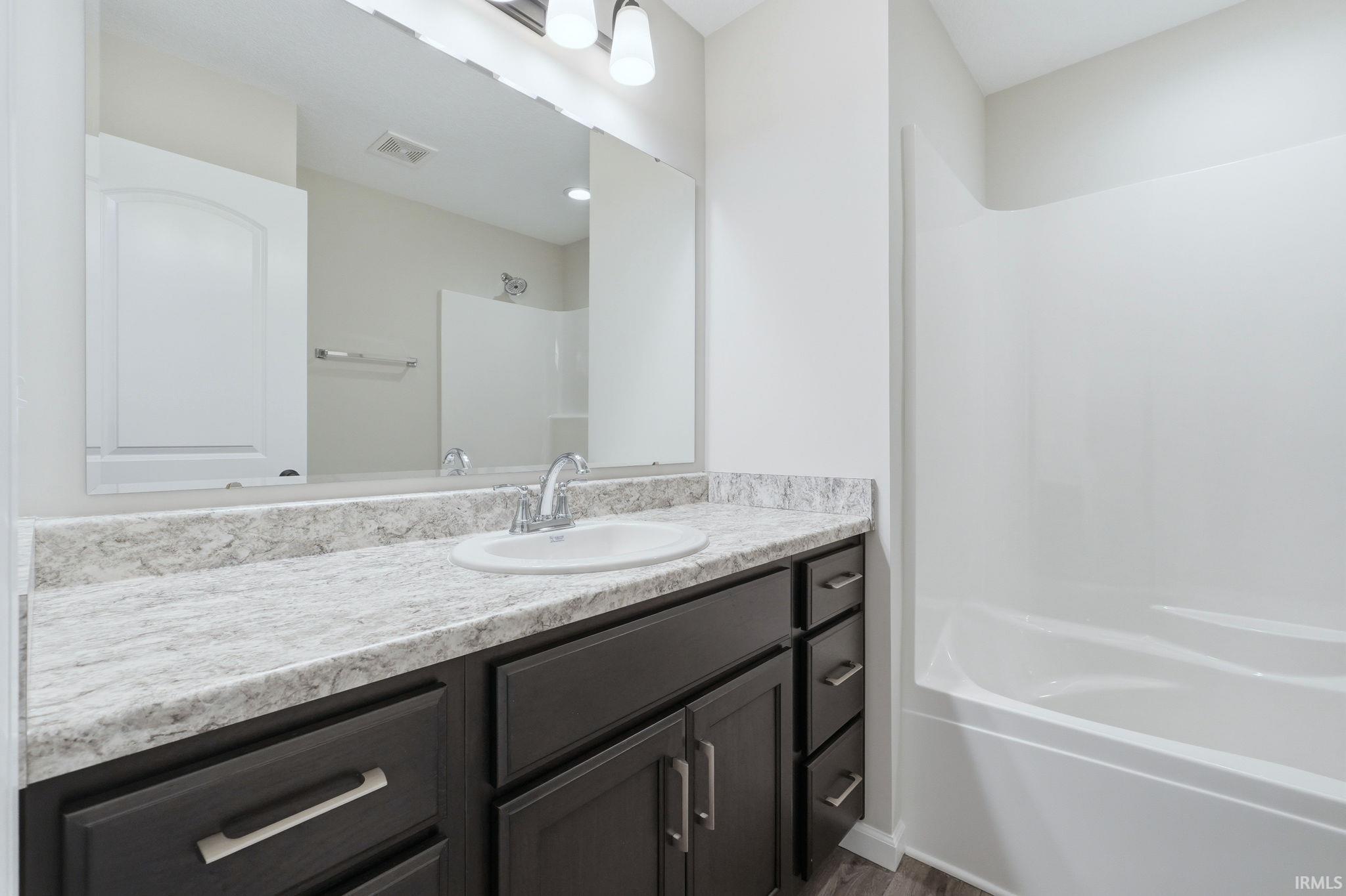 Full bath with vanity and shower / bath combination
