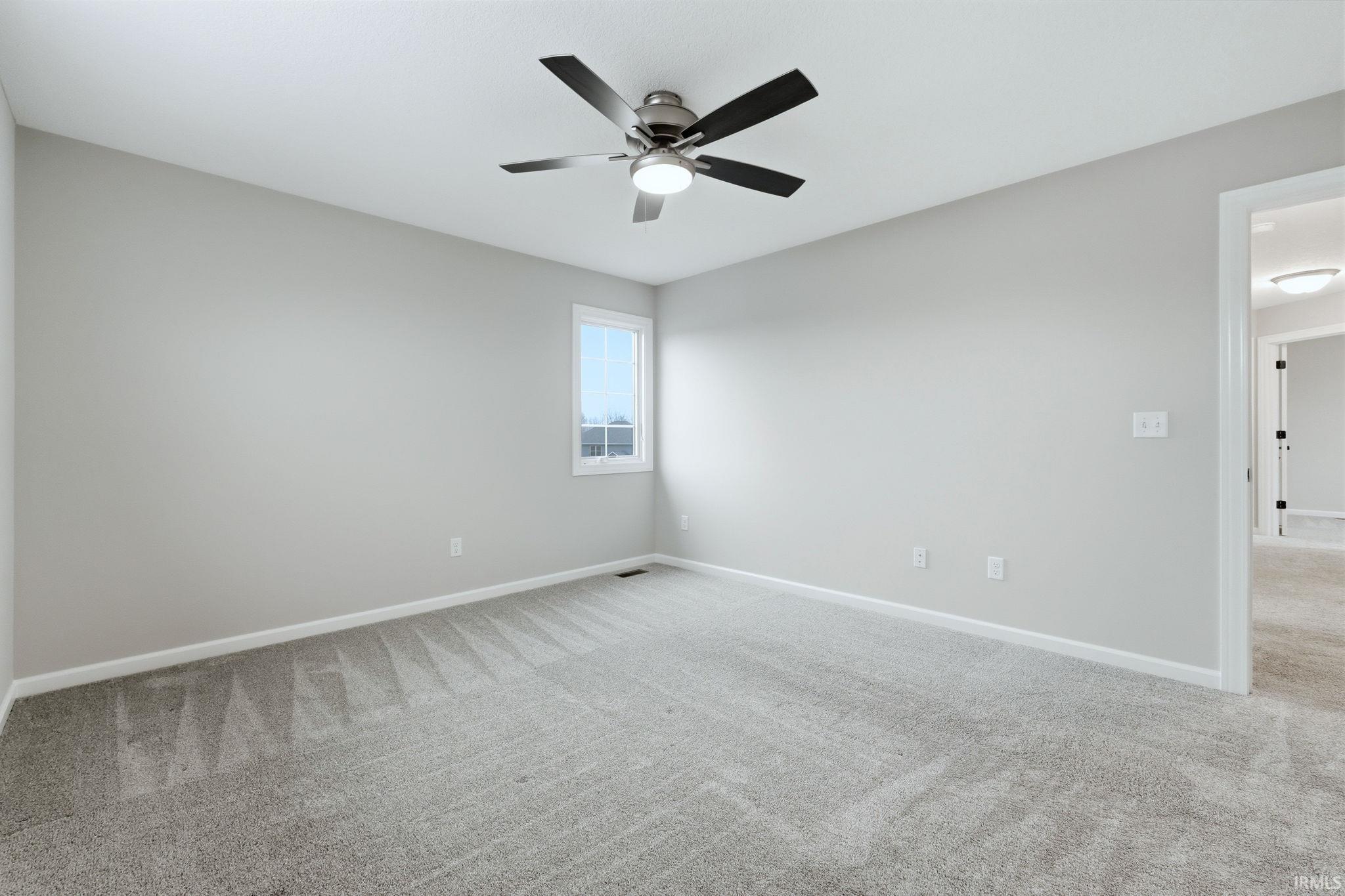 Unfurnished room with light carpet and a ceiling fan