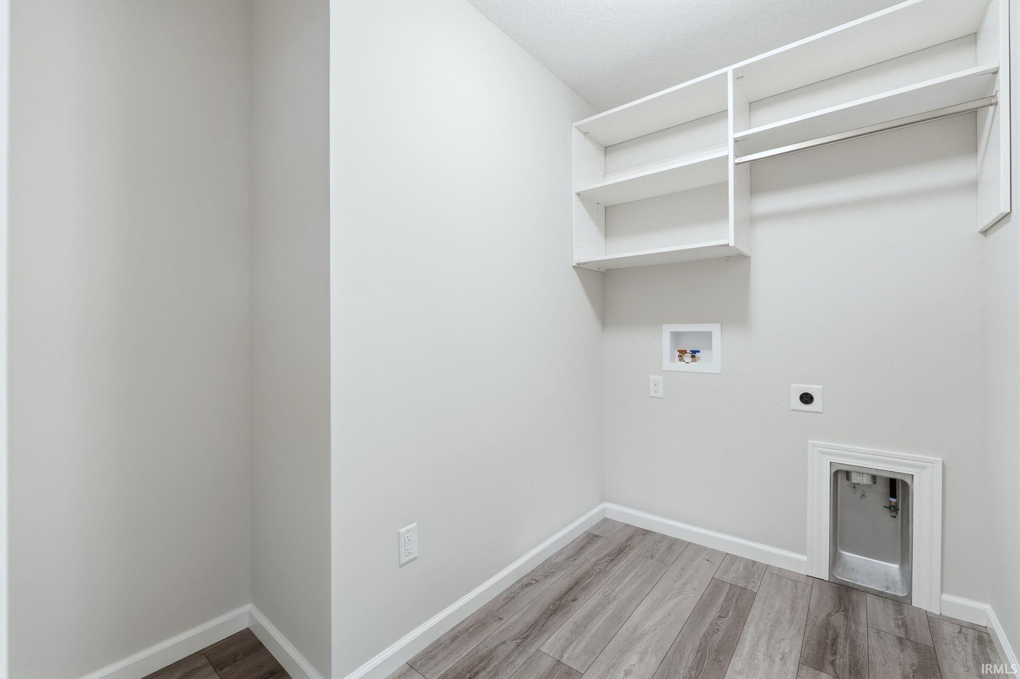 Laundry area featuring light wood-style floors, electric dryer hookup, and hookup for a washing machine