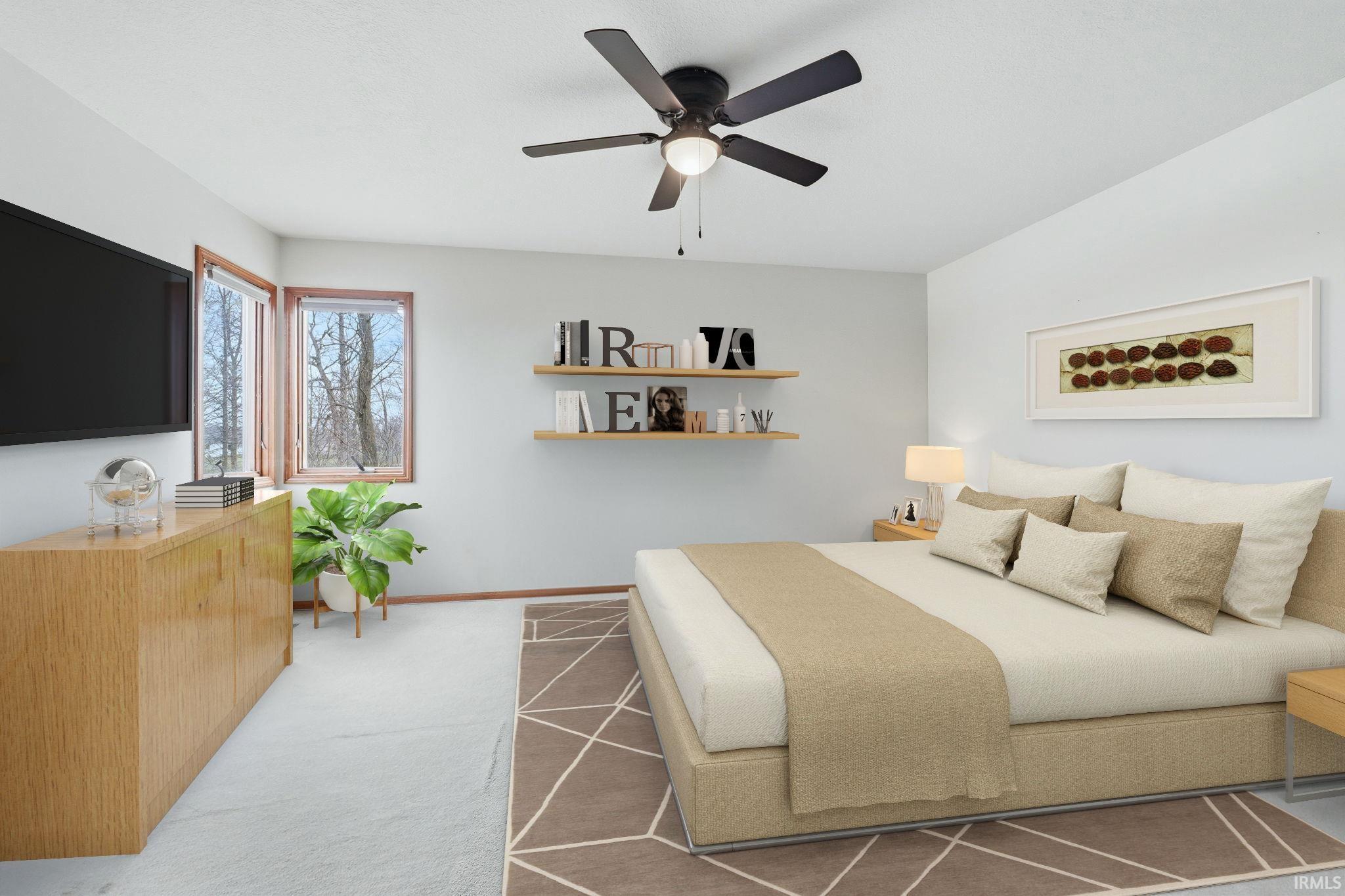 Bedroom featuring ceiling fan and light carpet