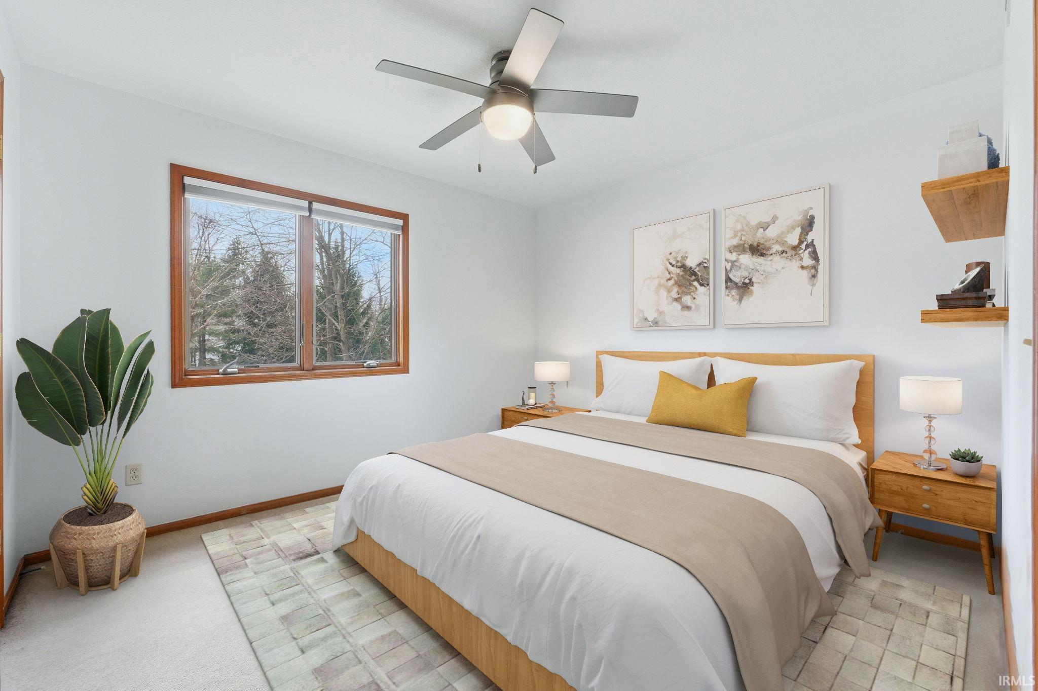 Bedroom featuring a ceiling fan and light carpet