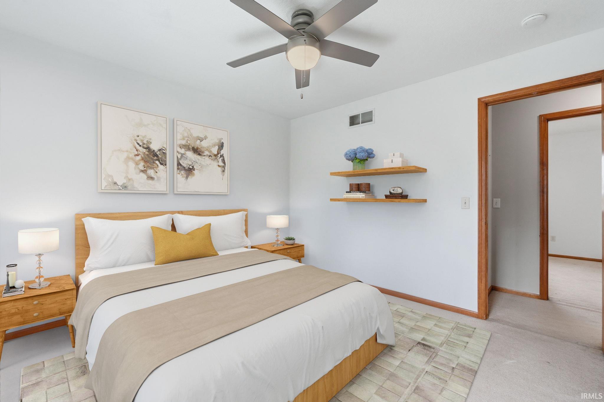 Bedroom with ceiling fan and light colored carpet