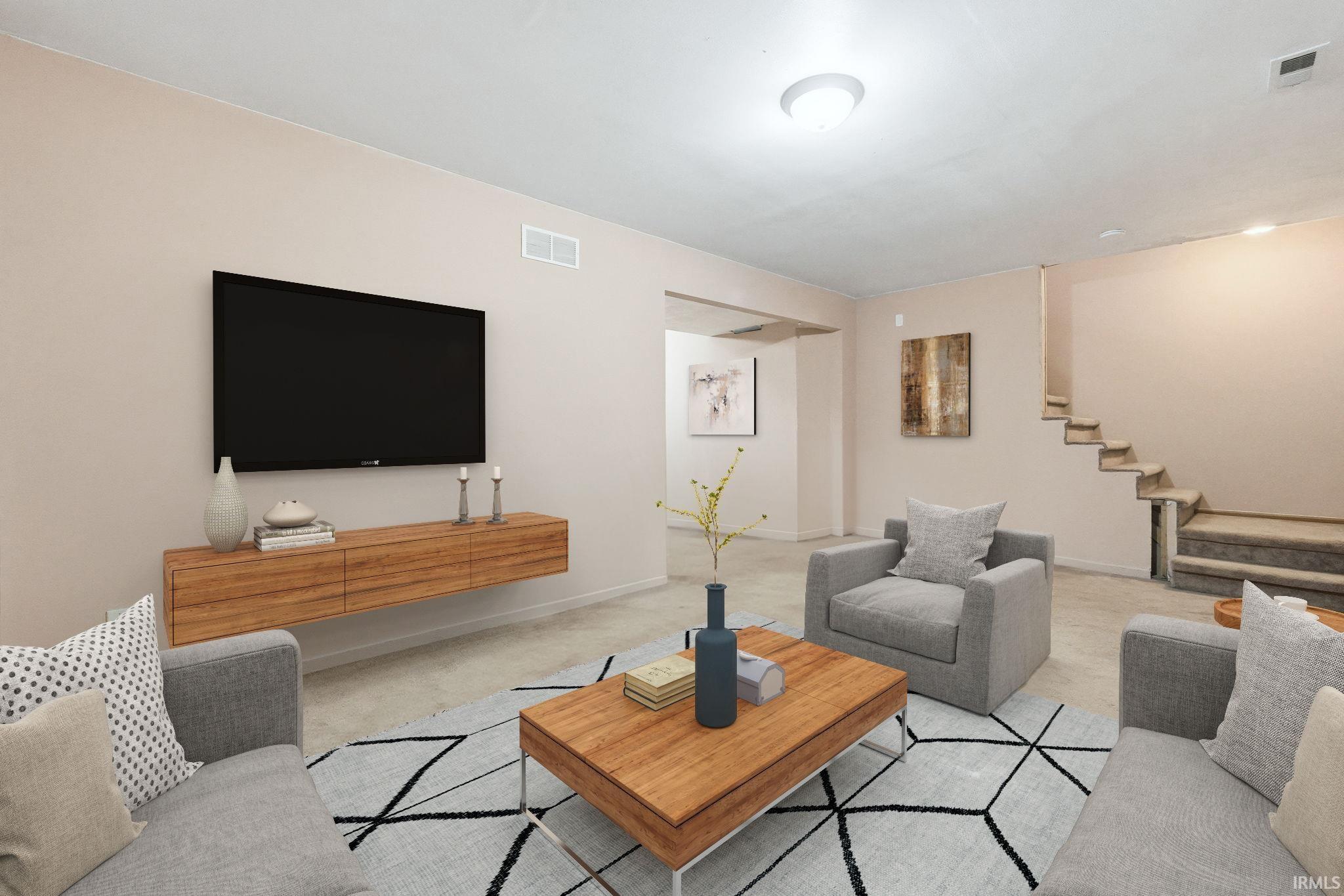 Living area with stairway and carpet