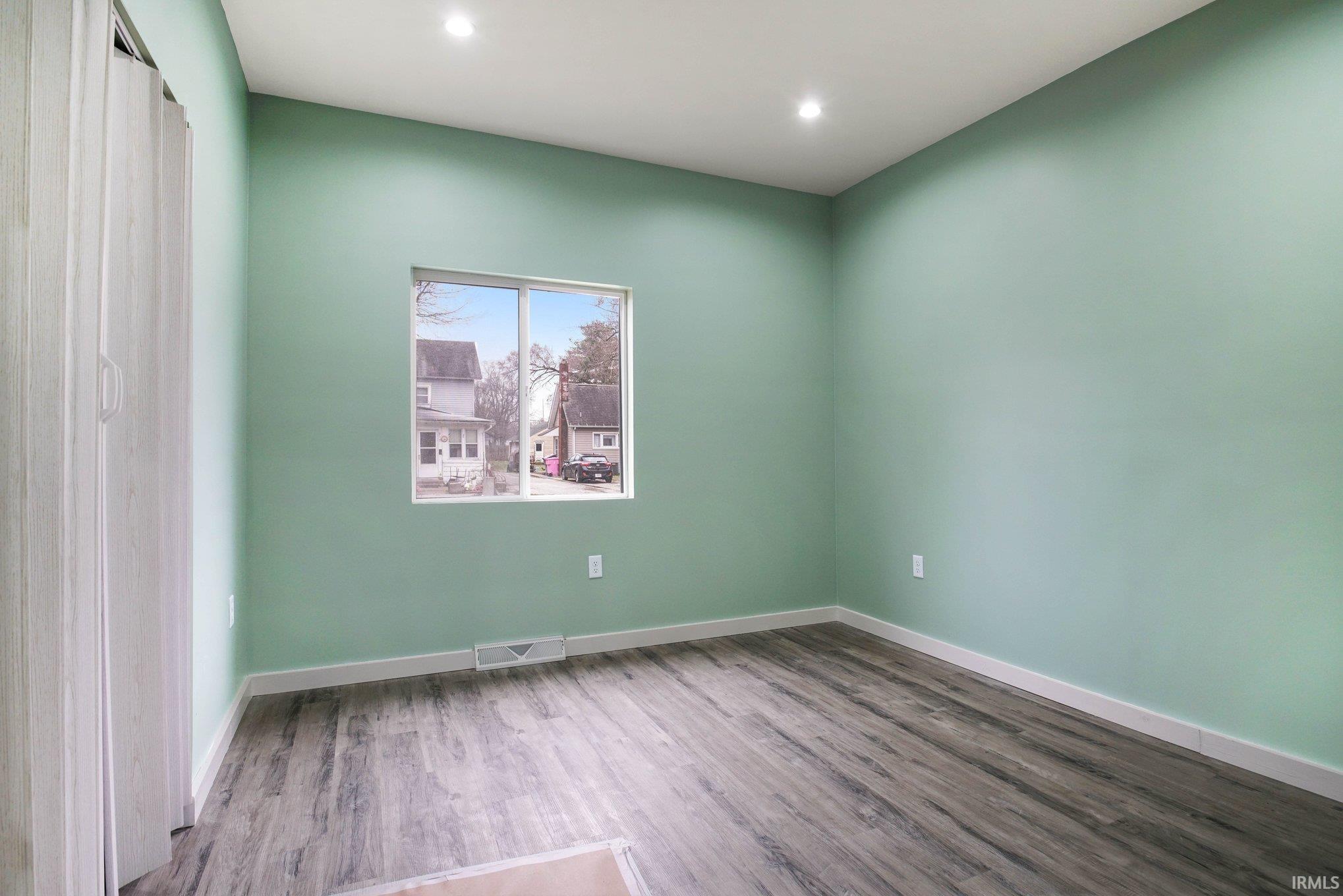 Unfurnished room with light wood-type flooring and recessed lighting