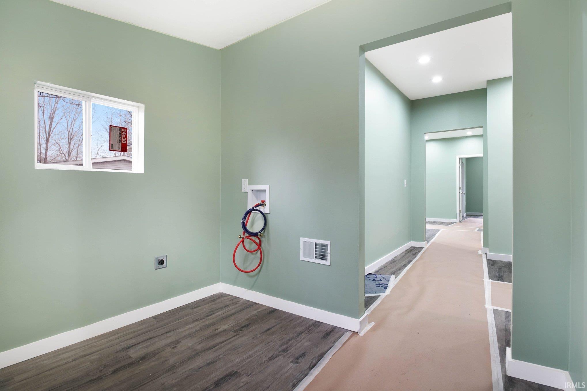 Hallway with baseboards and dark wood-style floors