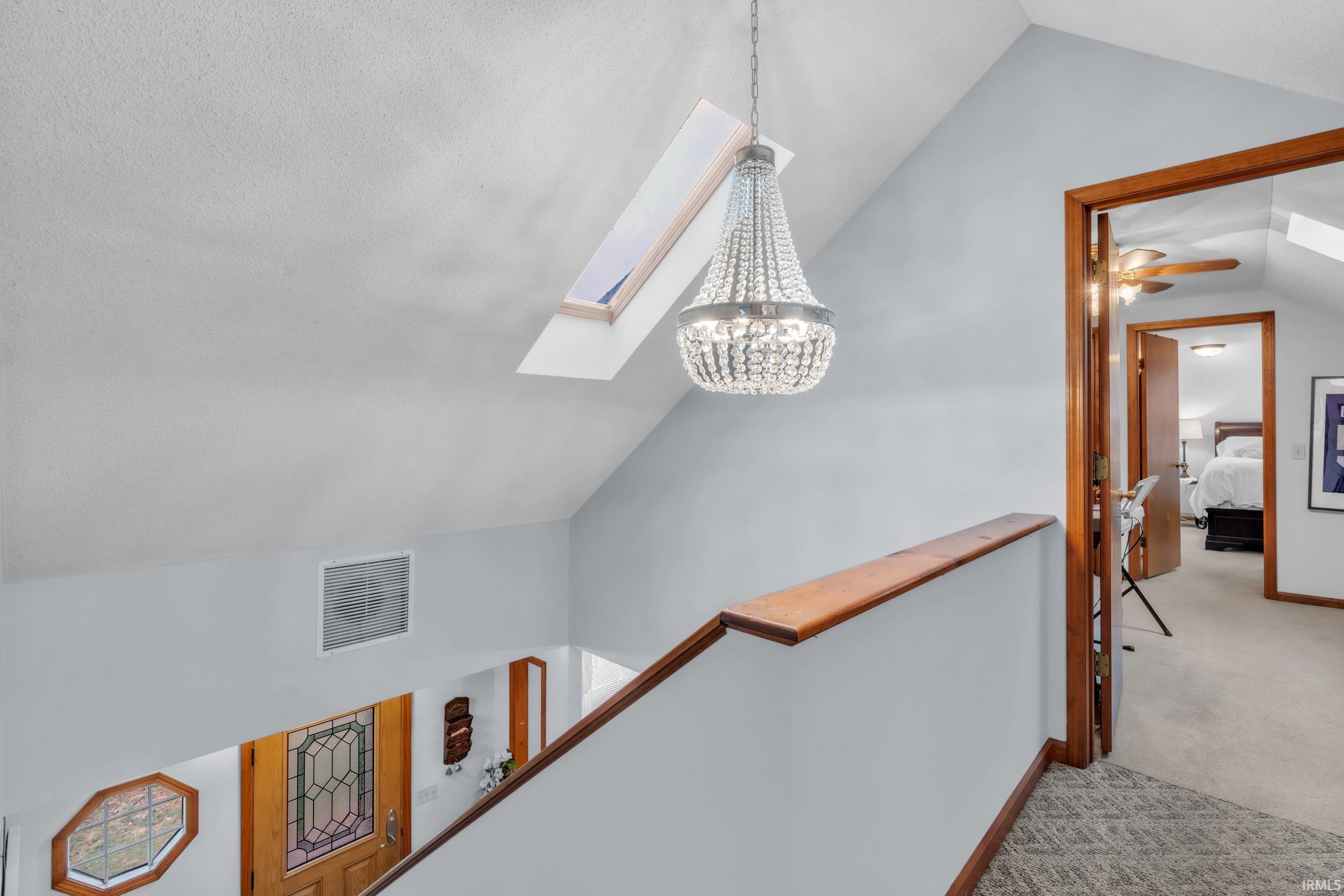 Detailed view of carpet flooring, a skylight, and ceiling fan