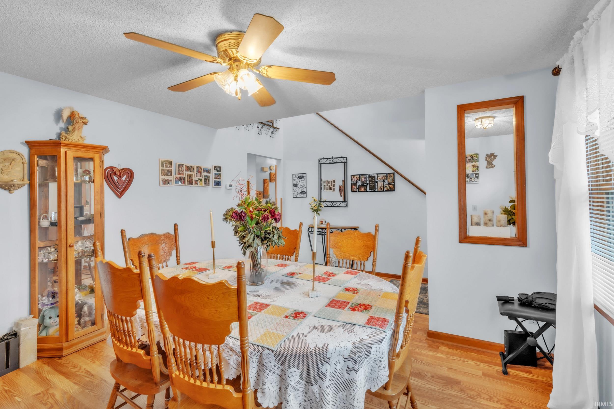 Dining area with light wood-style floors and a ceiling fan