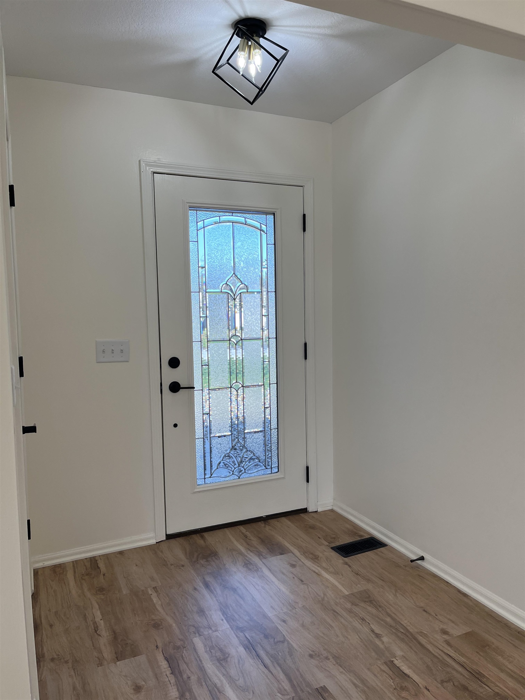 Entryway with light wood-type flooring and baseboards
