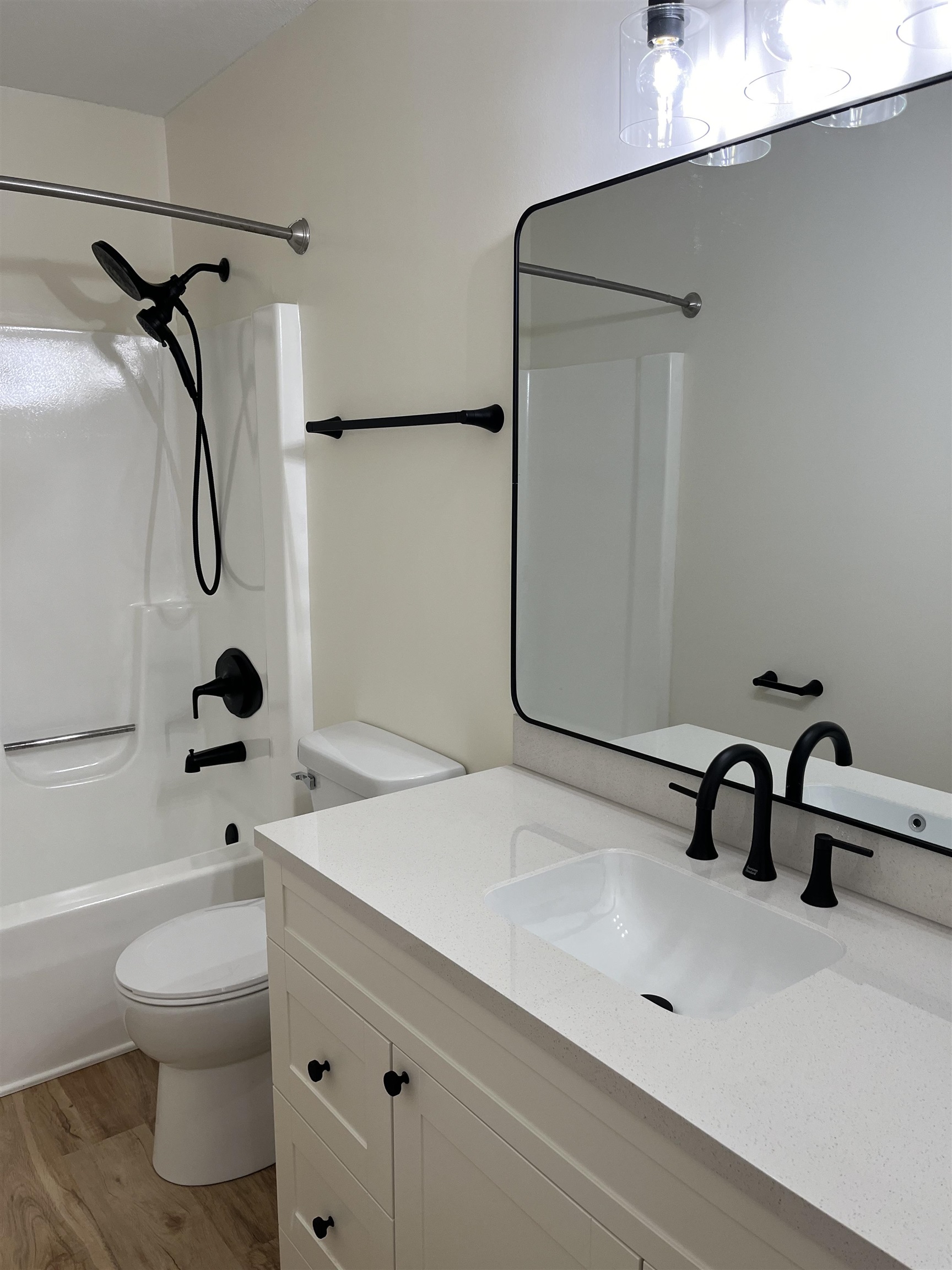 Full bath featuring vanity, shower / washtub combination, and light wood finished floors
