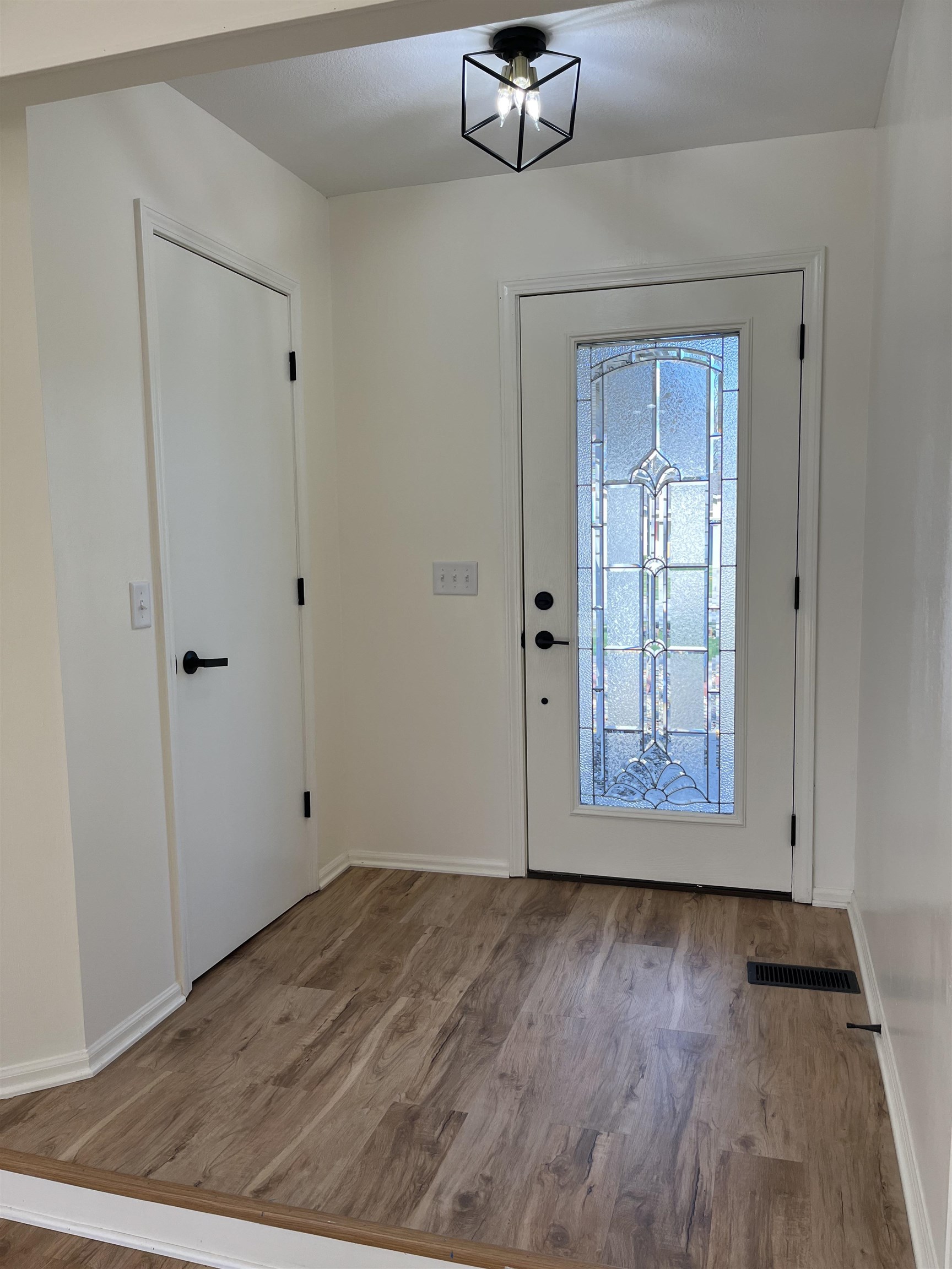 Entryway featuring wood finished floors and baseboards