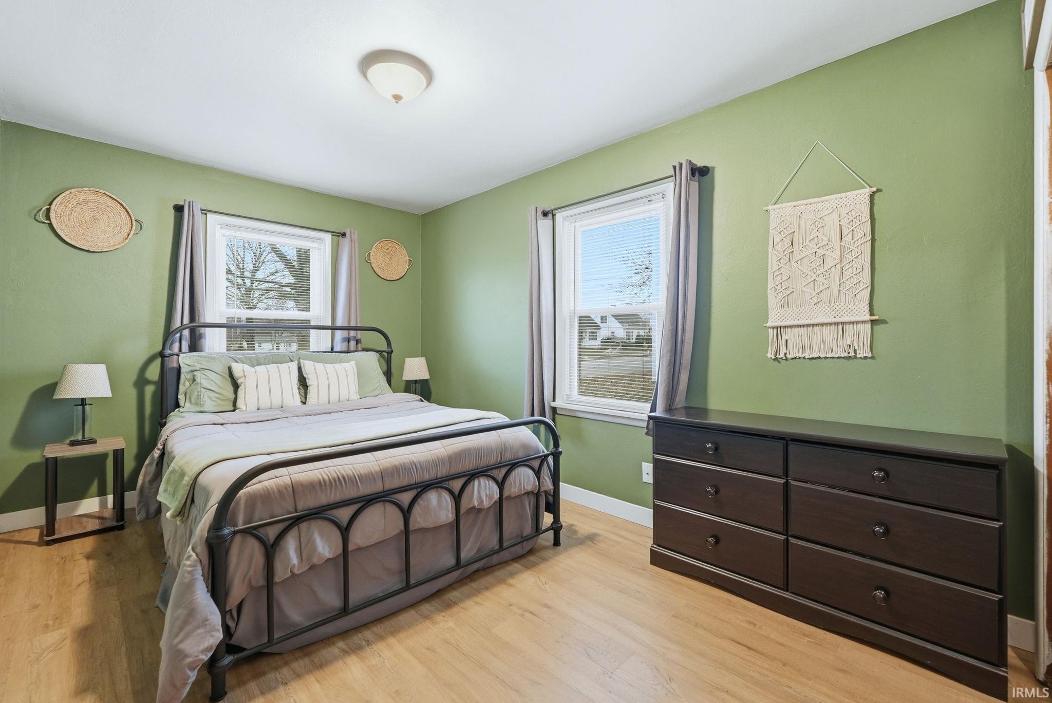Bedroom with light wood-type flooring and baseboards
