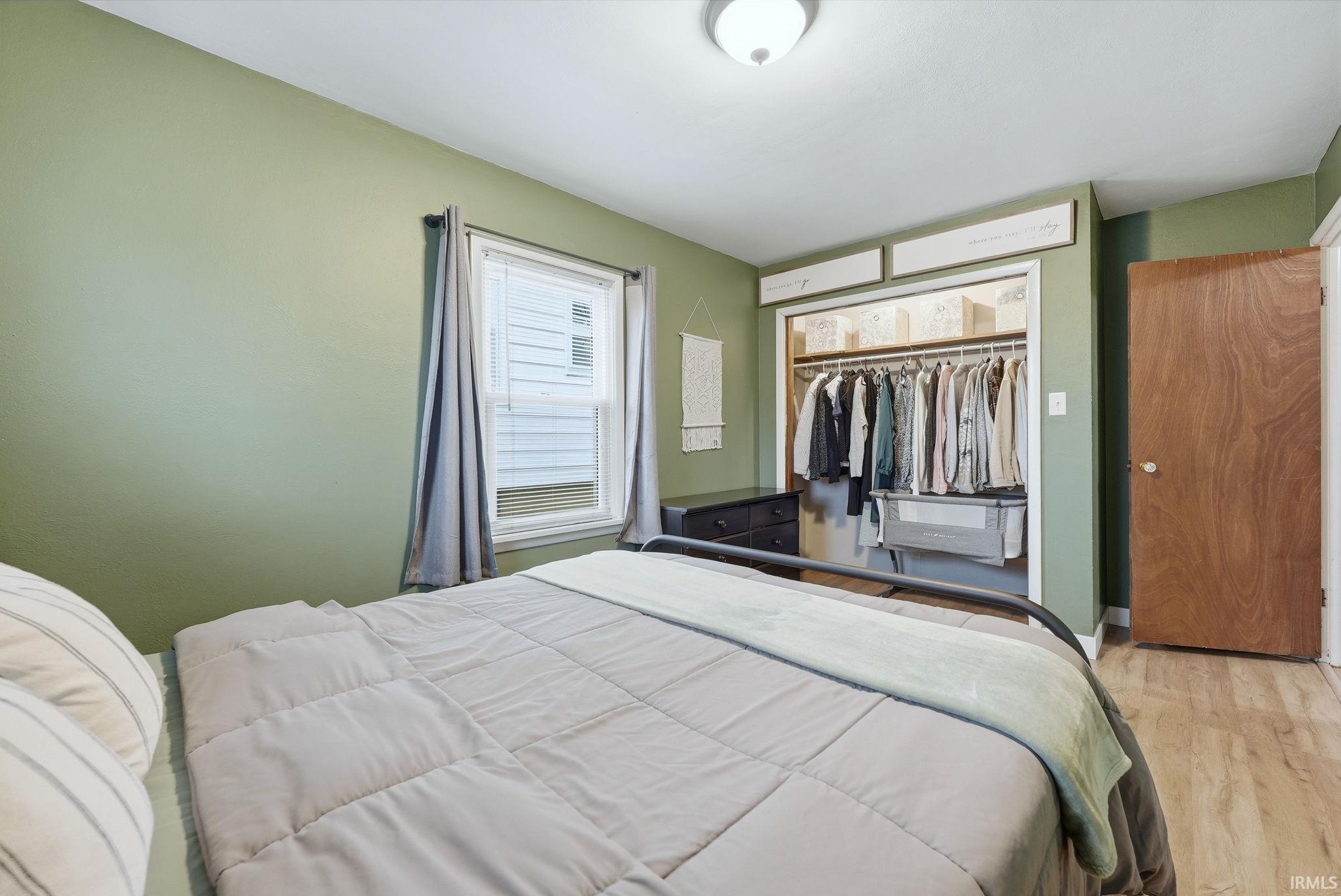 Bedroom featuring wood finished floors and a closet