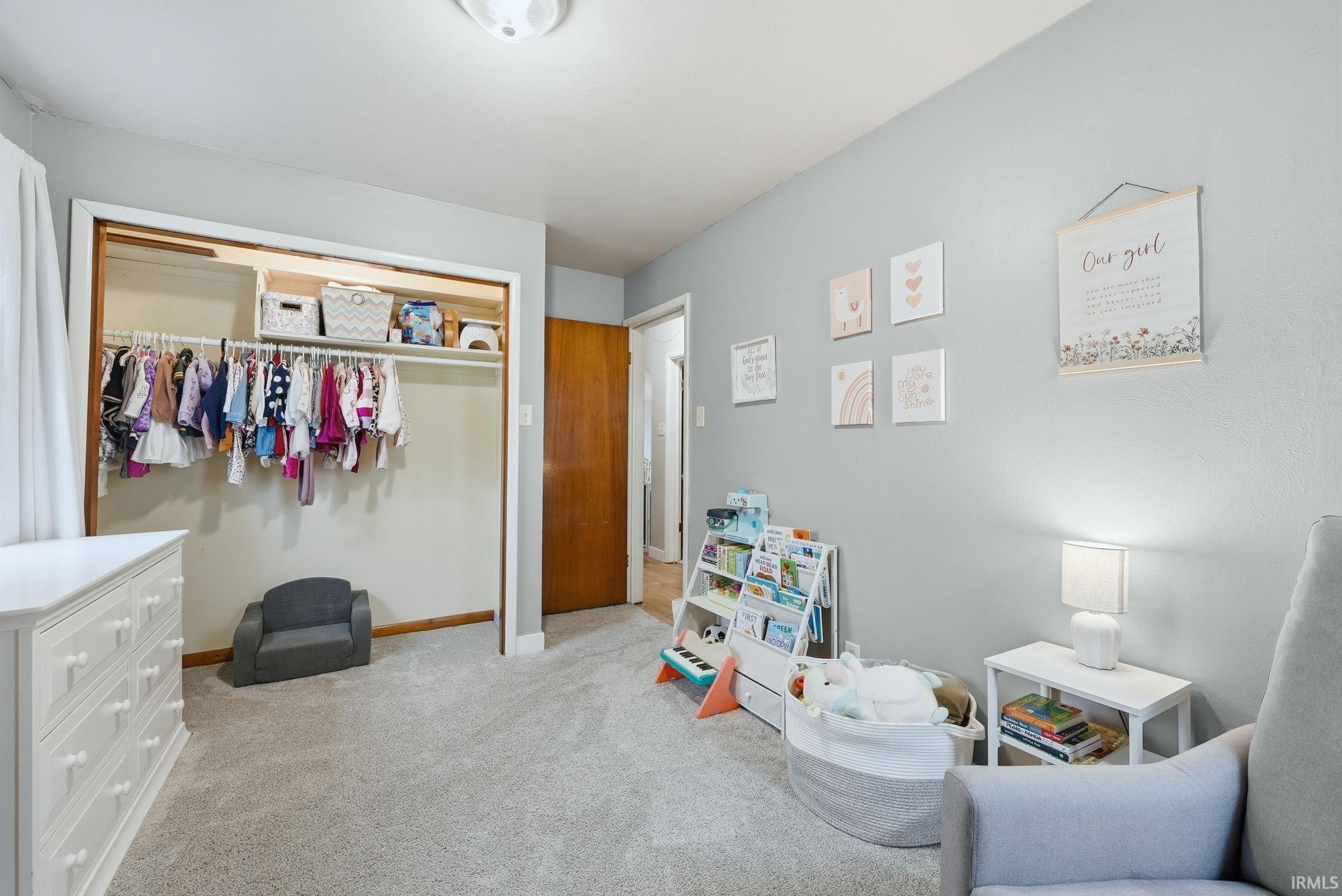 Bedroom featuring a closet and light colored carpet