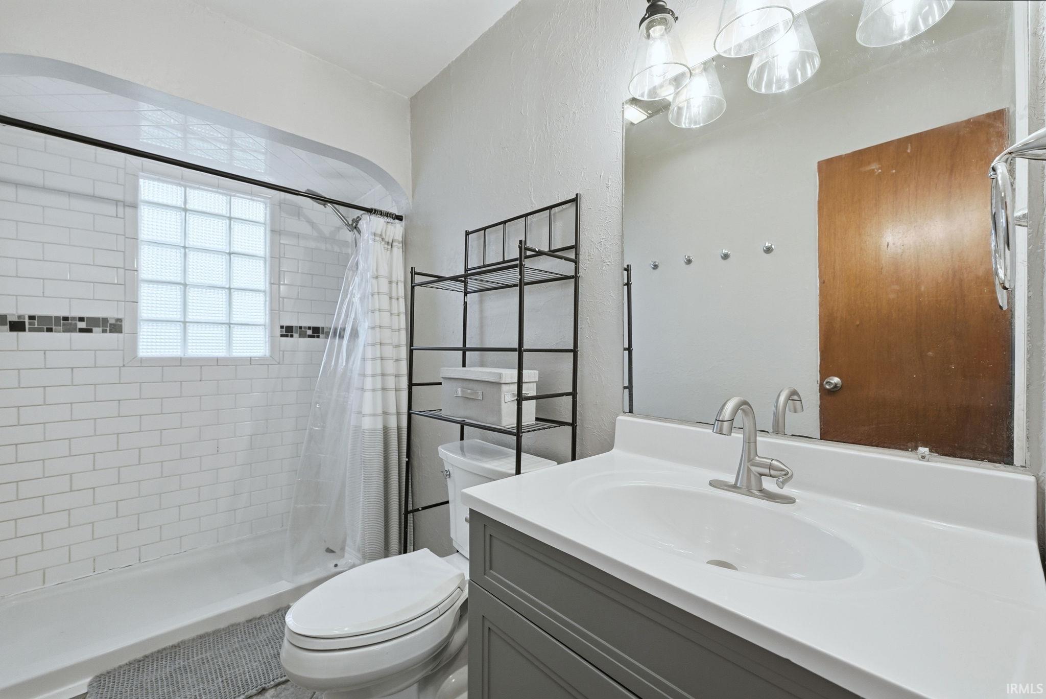 Full bathroom featuring vanity and a stall shower