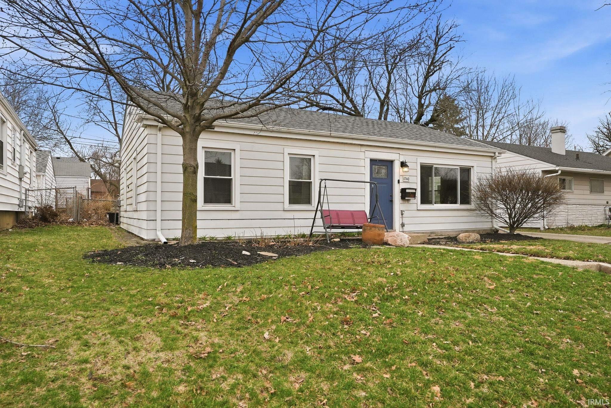 View of front of house with a shingled roof
