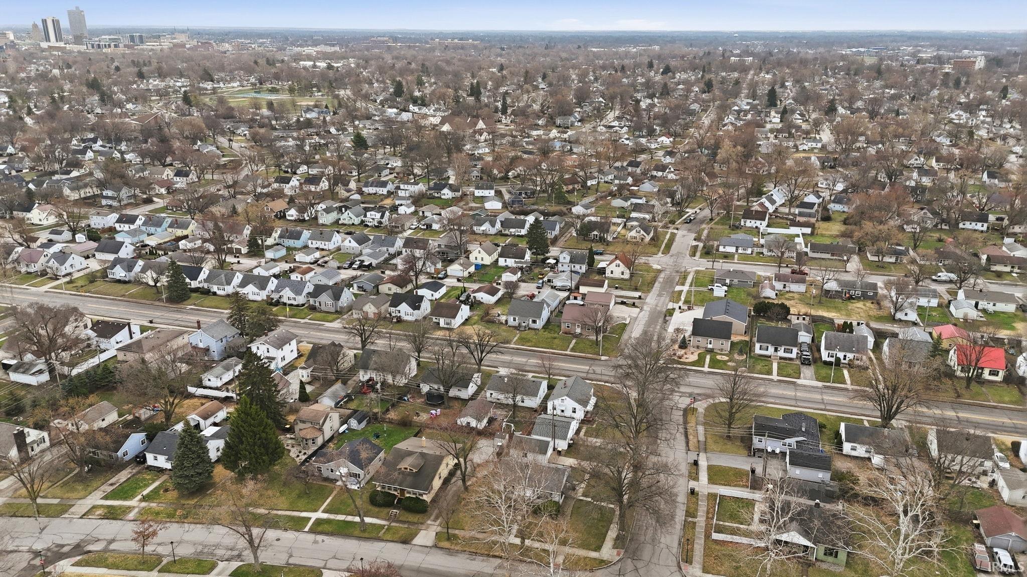 Aerial overview of property's location with nearby suburban area
