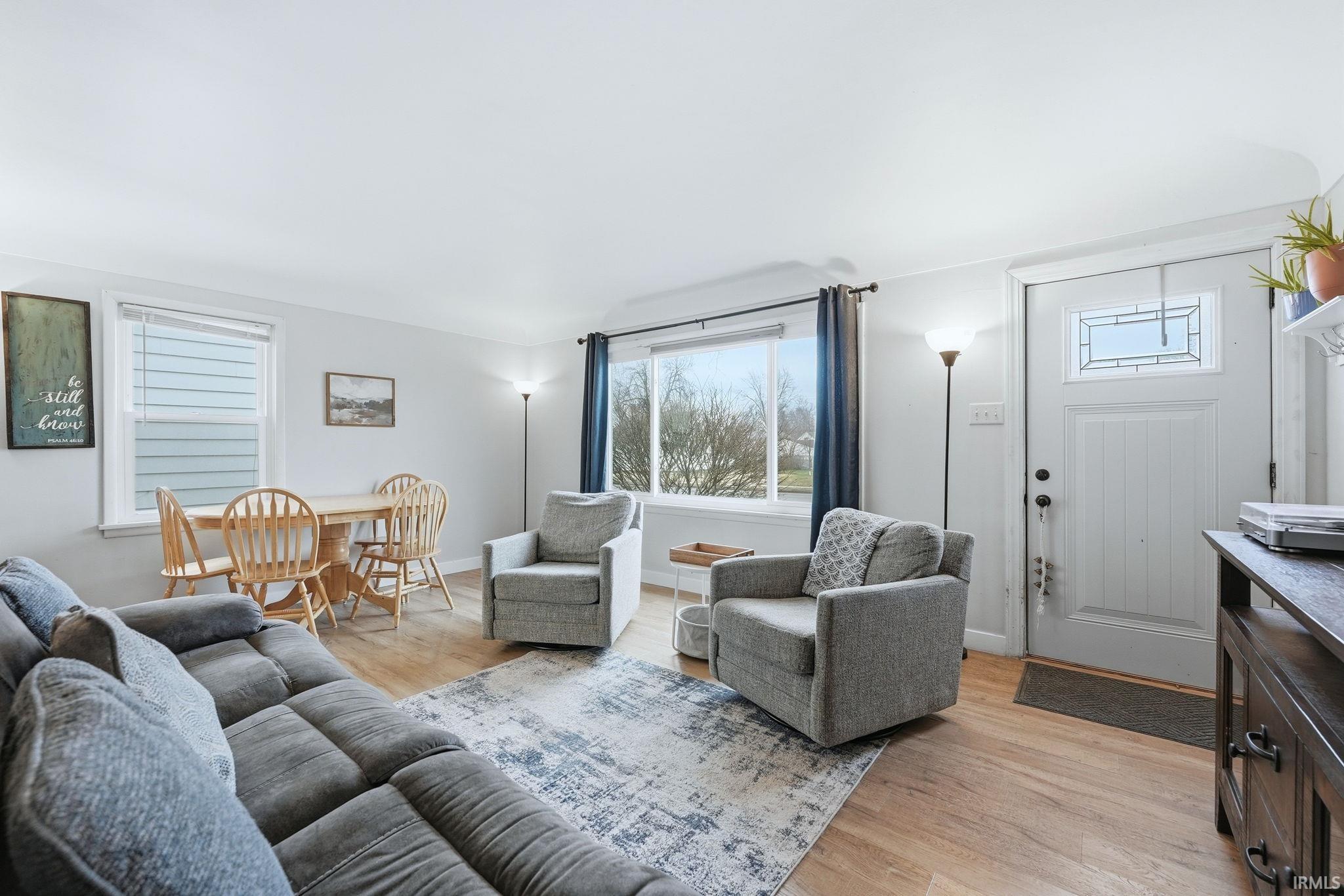 Living room featuring light wood-style flooring and baseboards