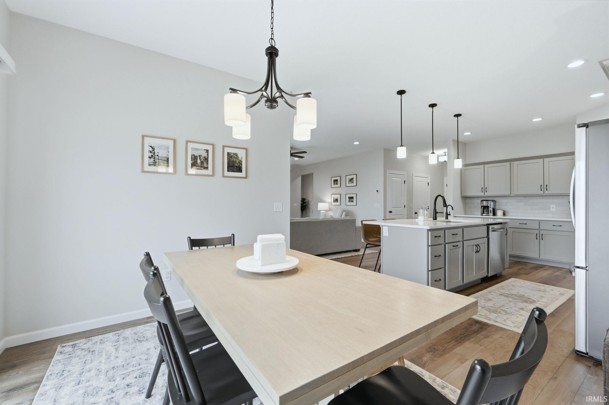 Dining space featuring light wood-style flooring and hanging lights