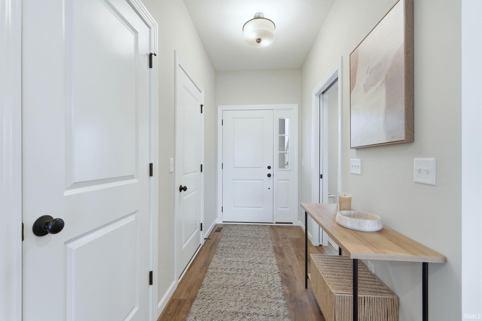 Doorway featuring wood finished floors