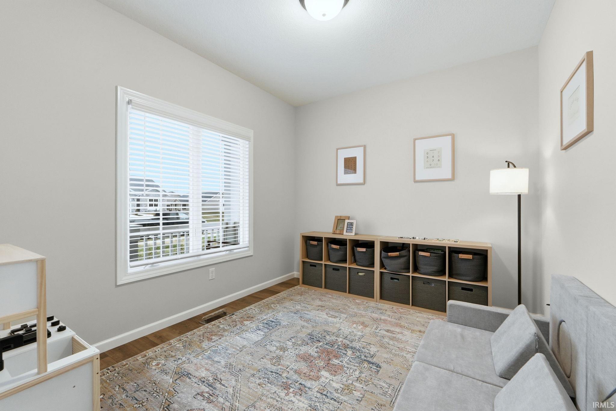 Sitting room featuring wood finished floors and baseboards