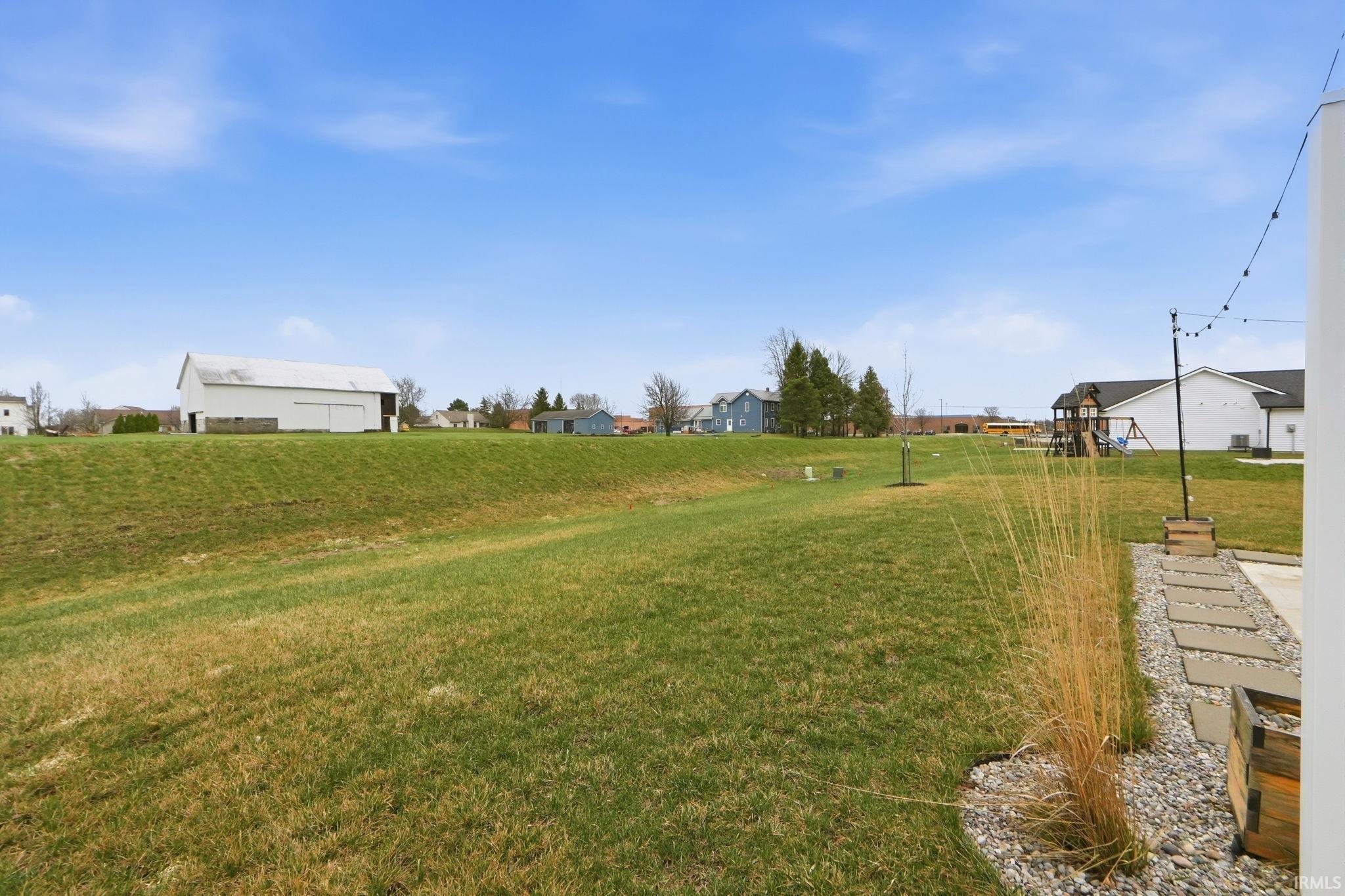 View of green lawn with a residential view