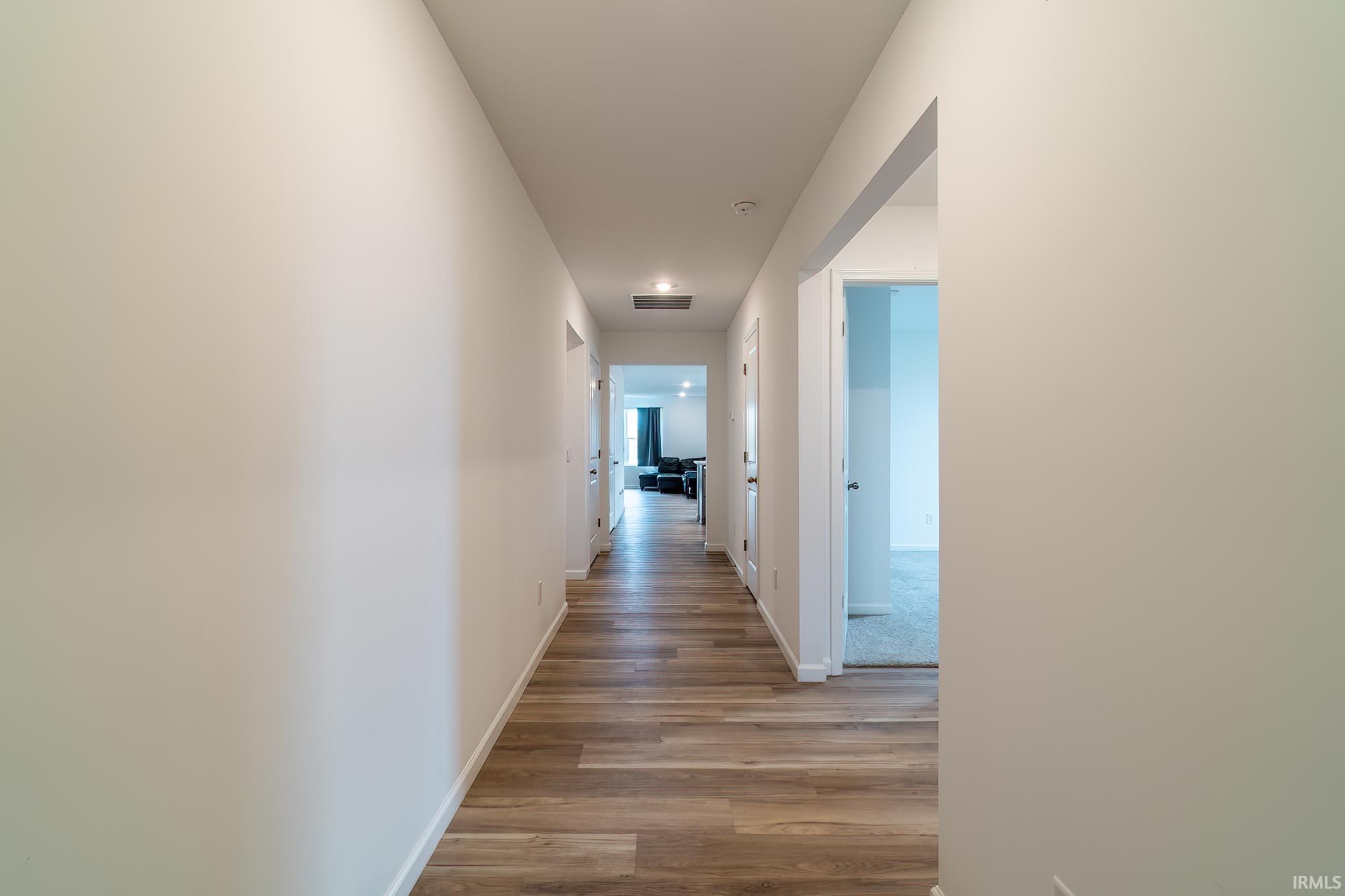 Hall featuring baseboards and light wood-style flooring