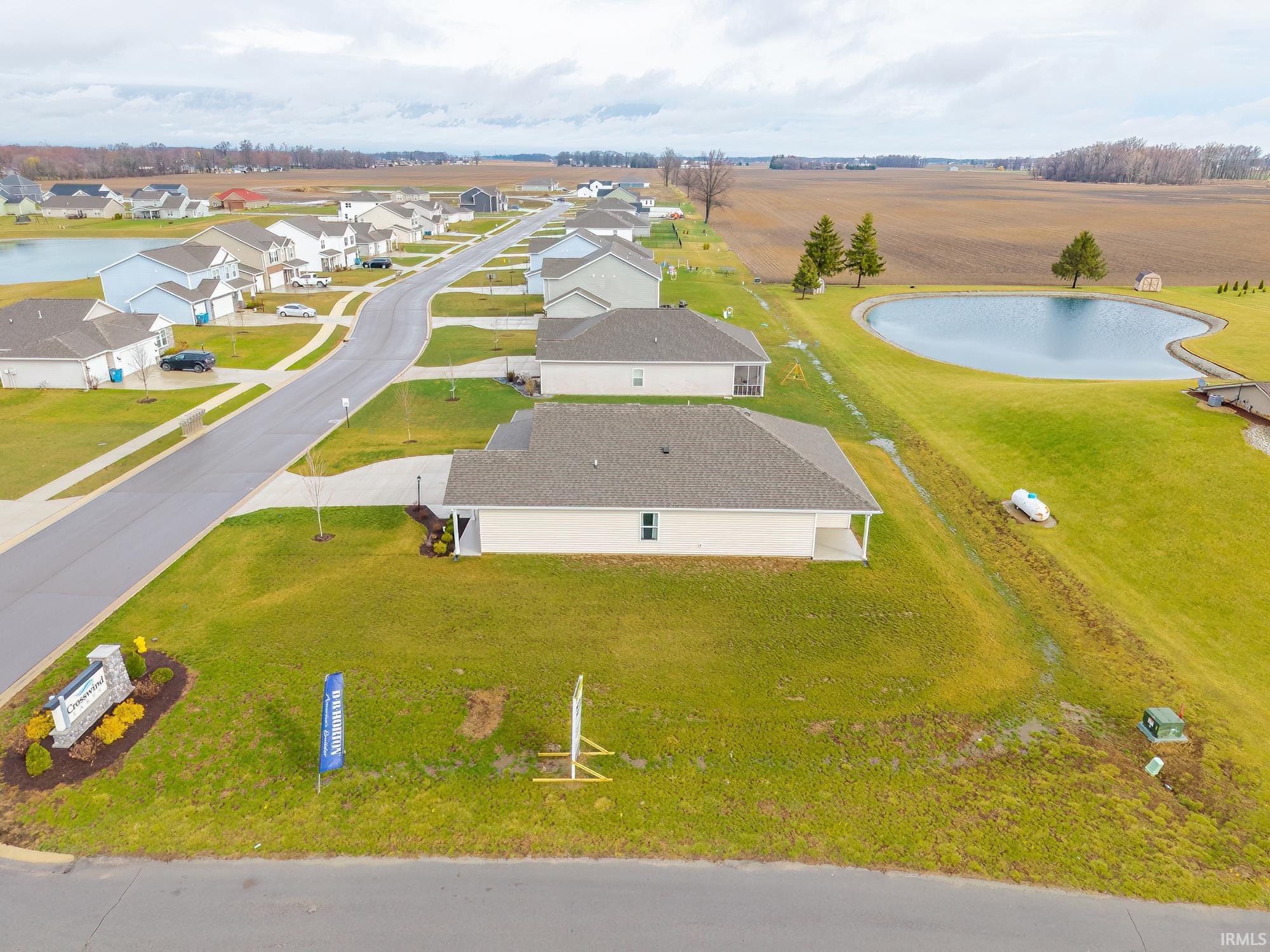 Aerial perspective of suburban area featuring a large body of water