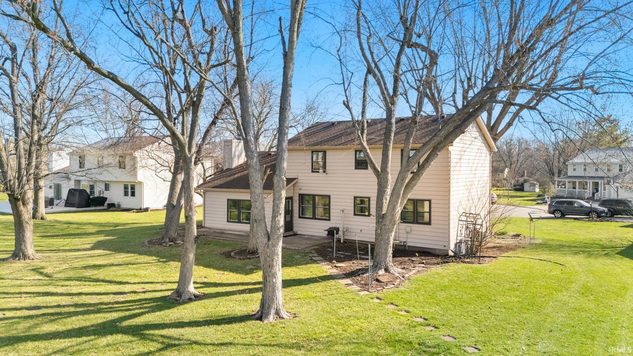Back of property featuring a yard and a patio area