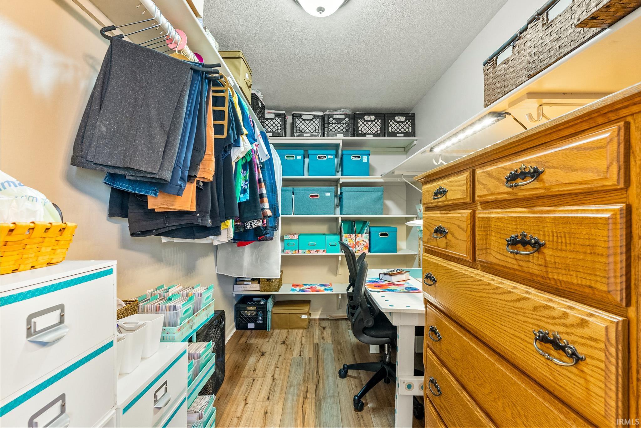 Walk in closet featuring light wood-type flooring