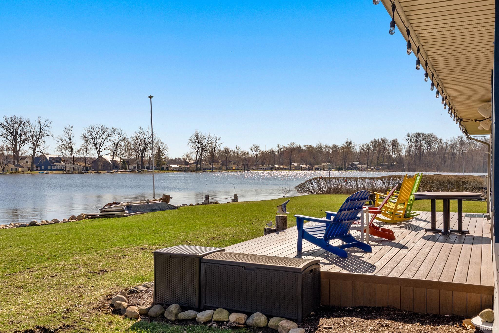 Wooden deck with a yard and a water view