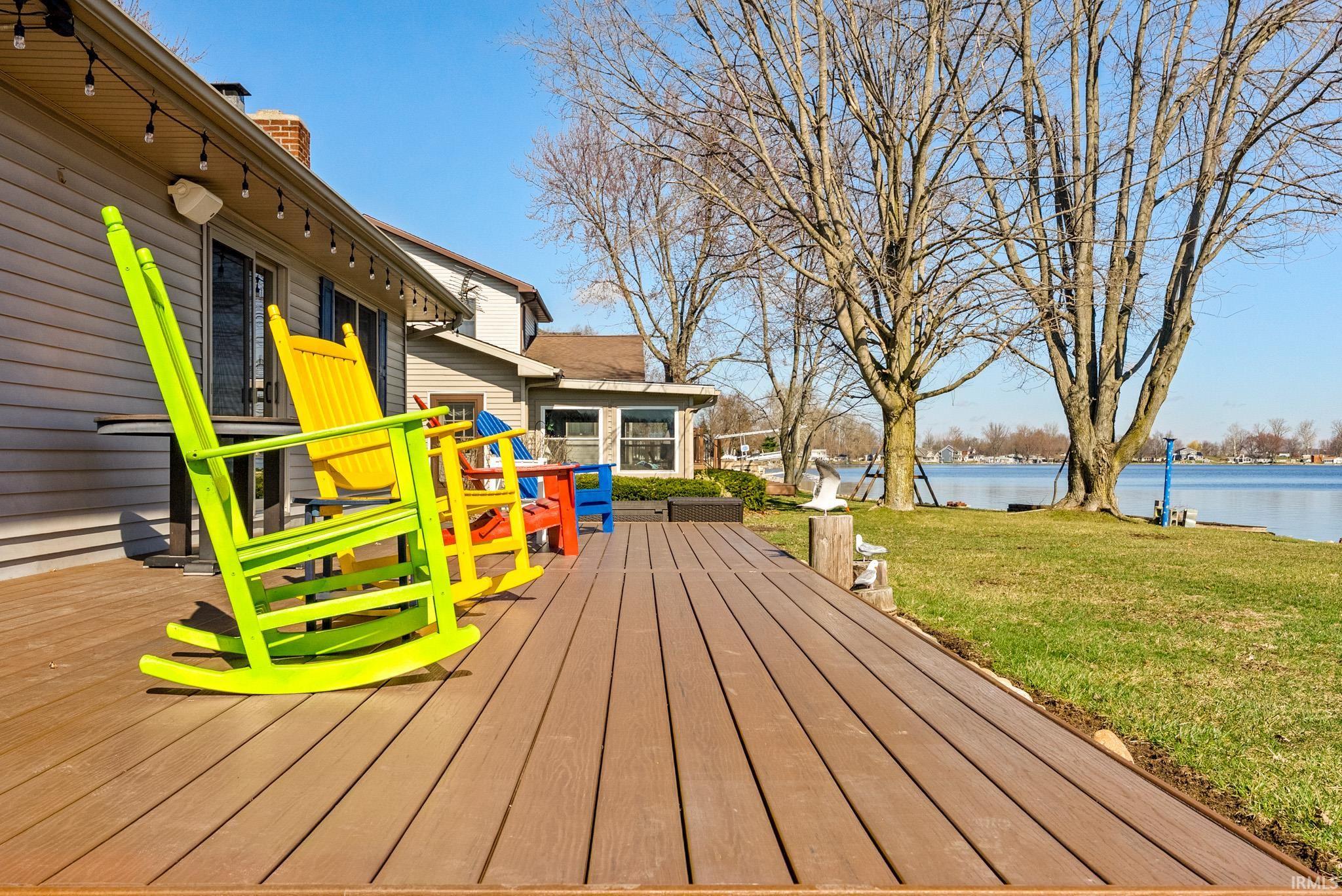 Wooden deck with a yard and a water view