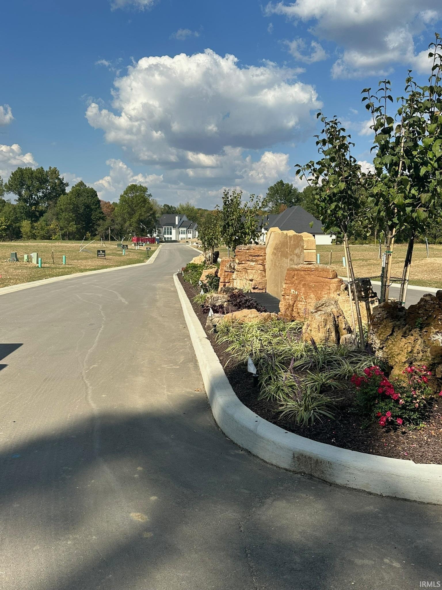 View of asphalt road with curbs