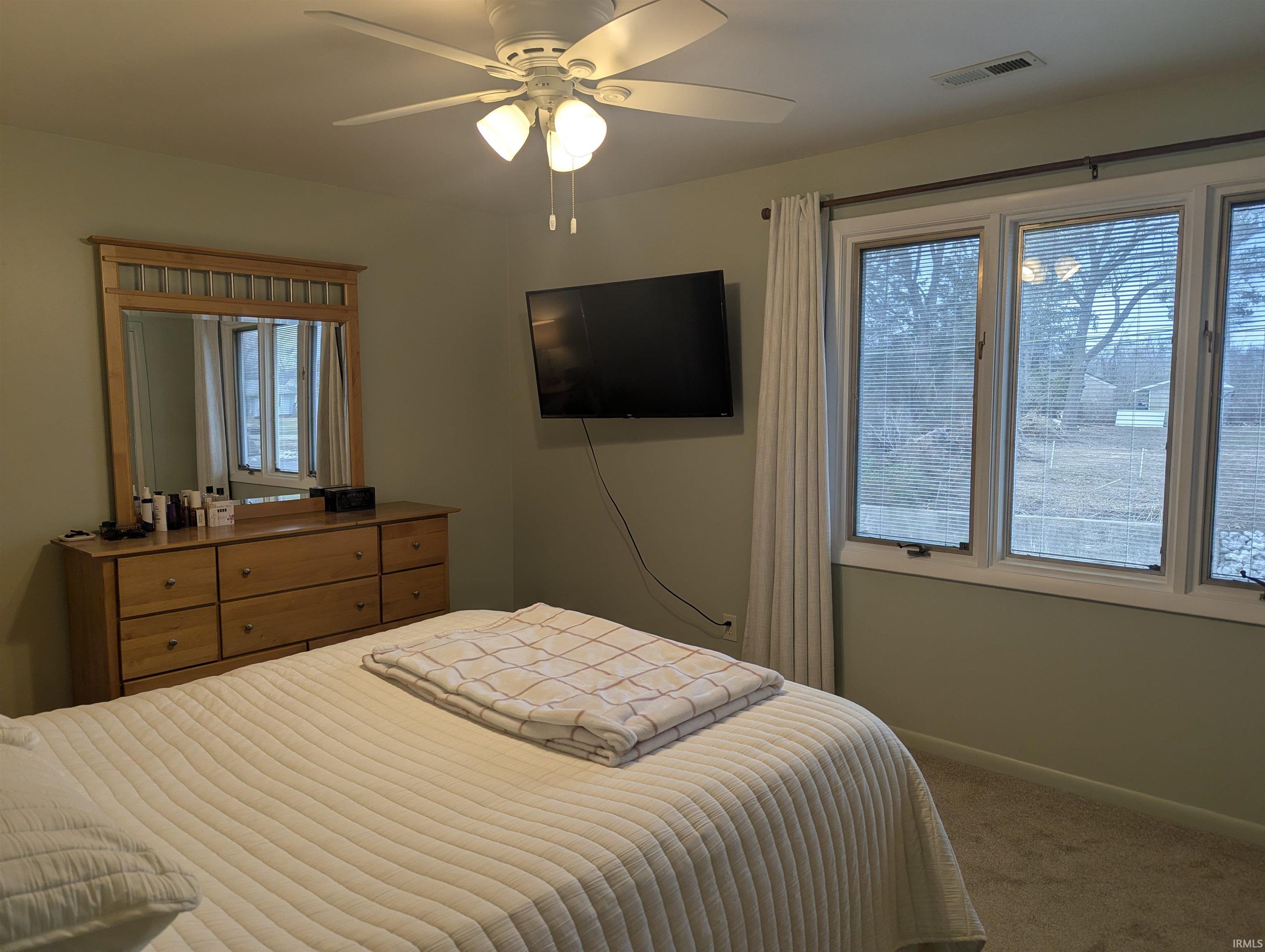 Bedroom featuring carpet and ceiling fan