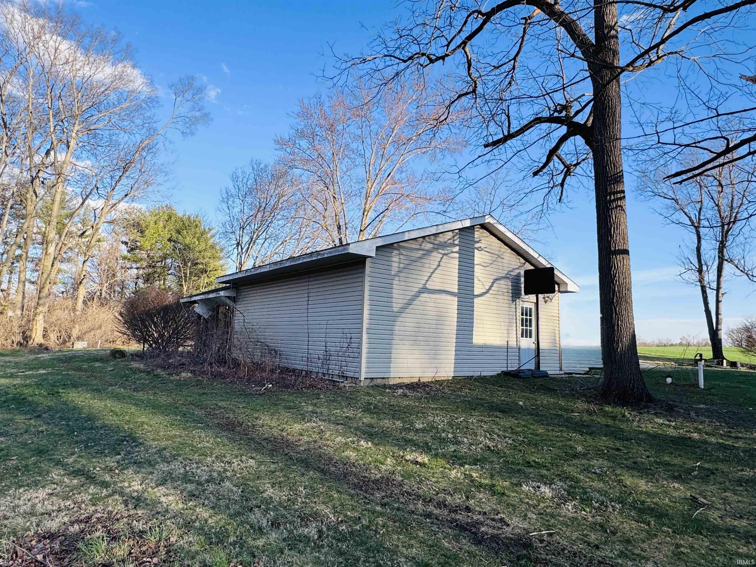 View of side of home featuring a yard