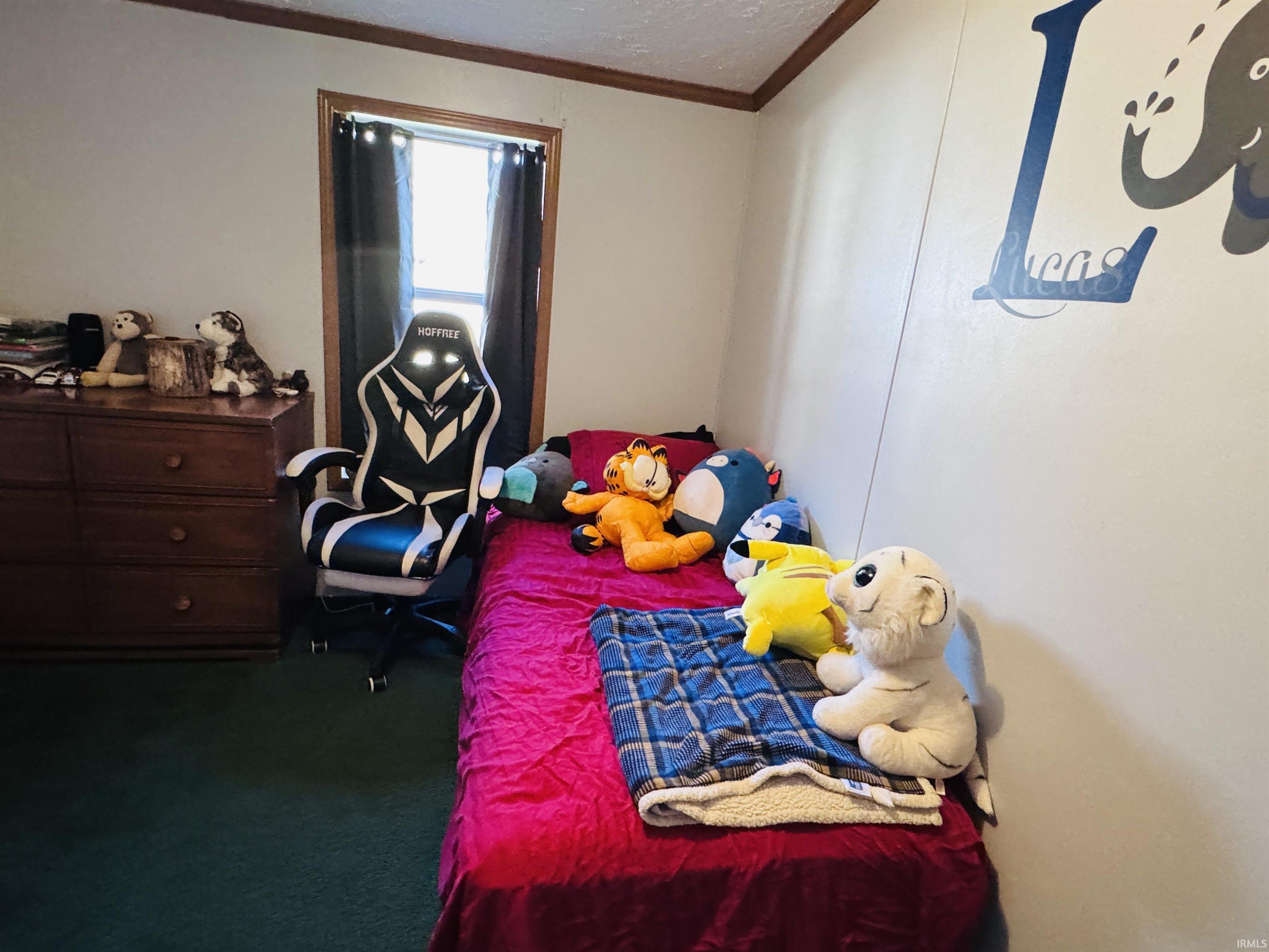 Bedroom with crown molding and dark carpet
