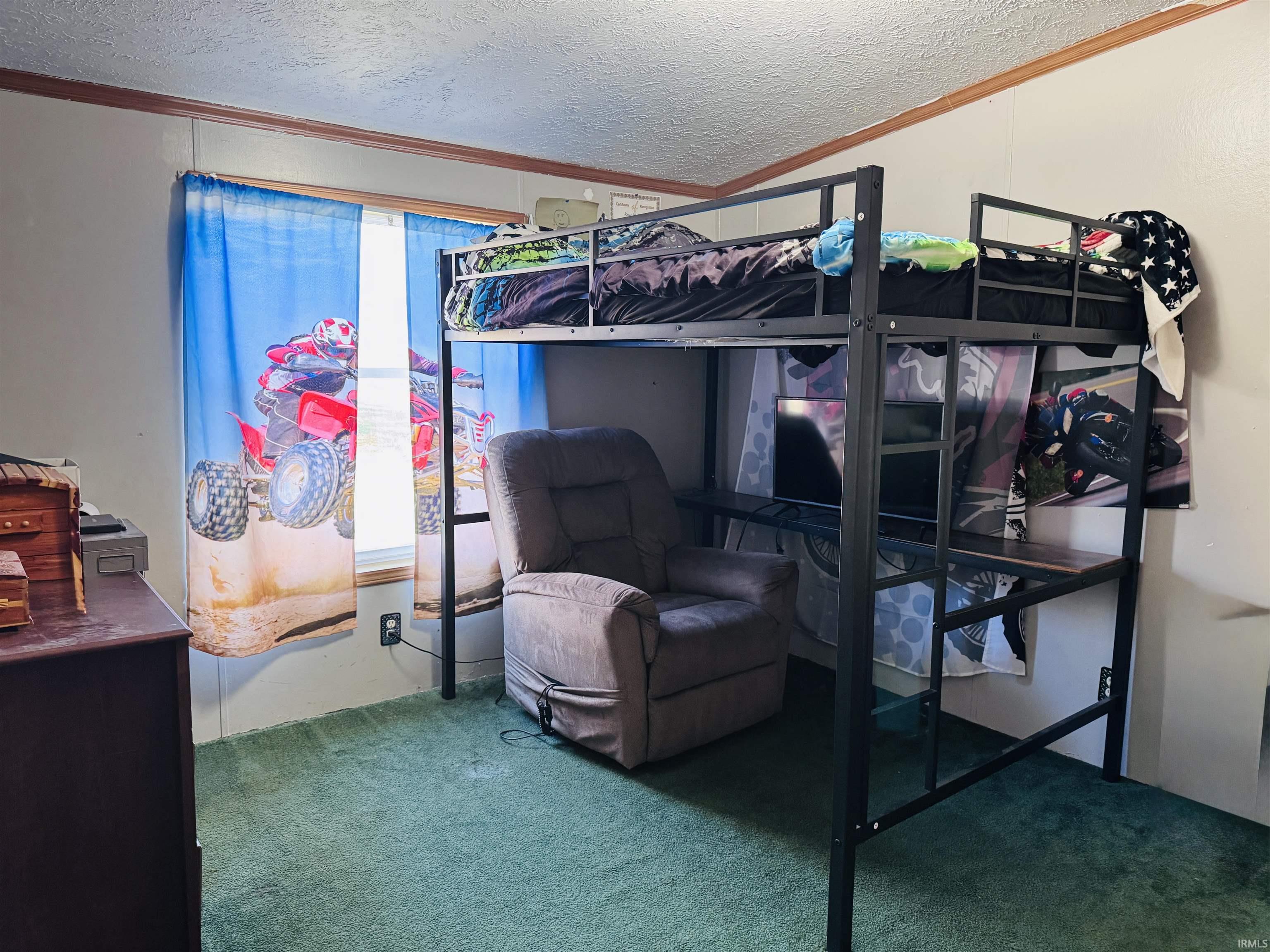 Bedroom with carpet flooring, a textured ceiling, and crown molding