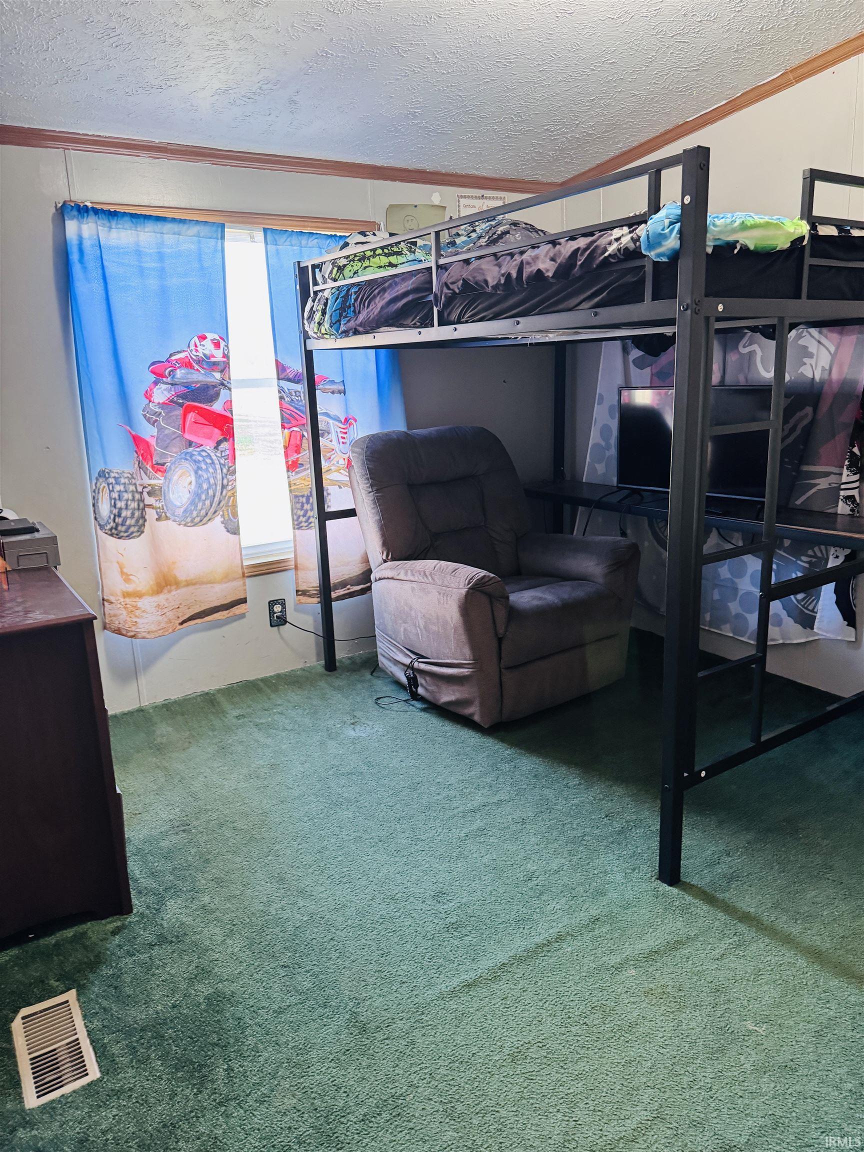 Carpeted bedroom with a textured ceiling