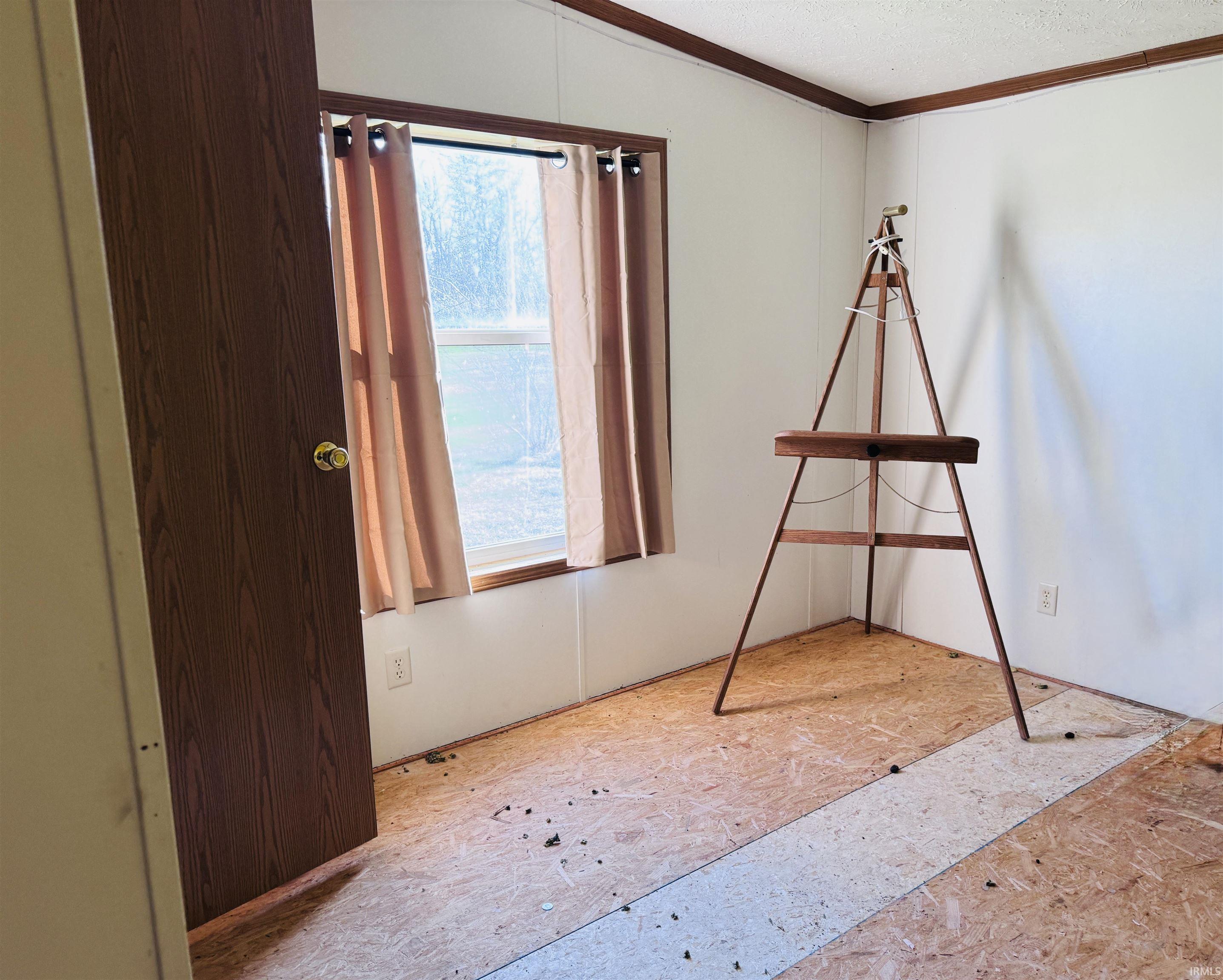 Unfurnished bedroom with ornamental molding