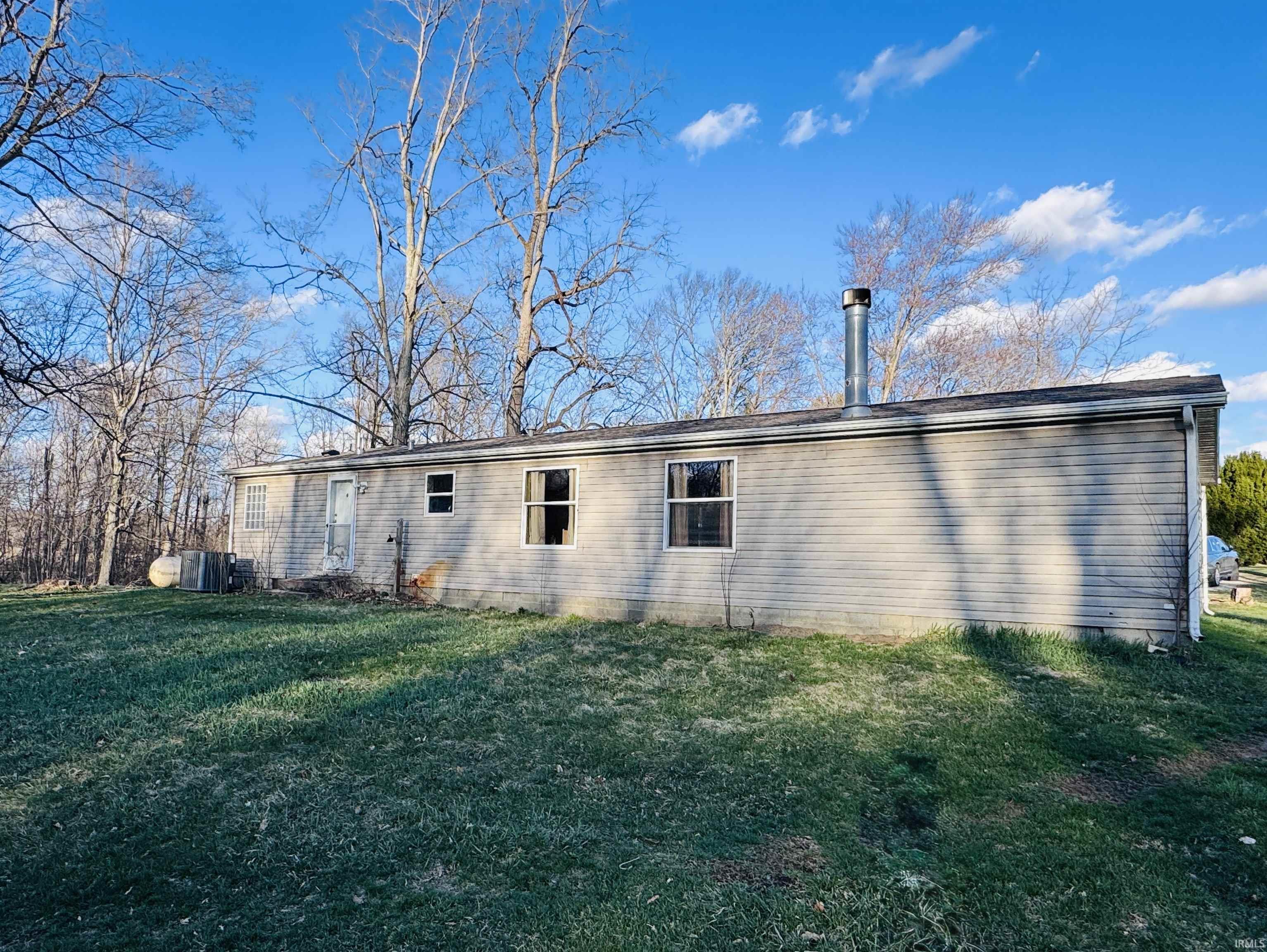 Back of property featuring a yard