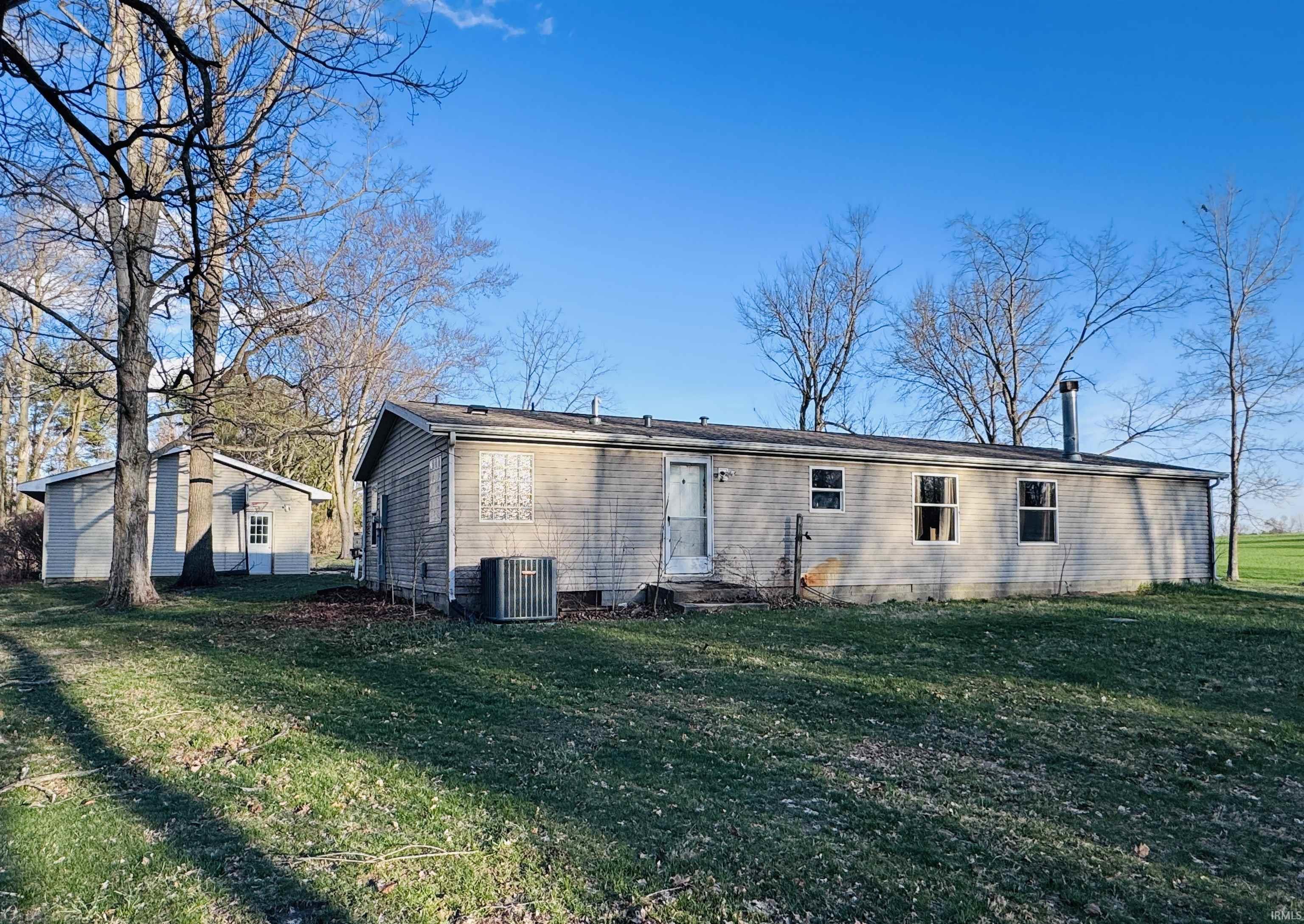 Back of property featuring a lawn