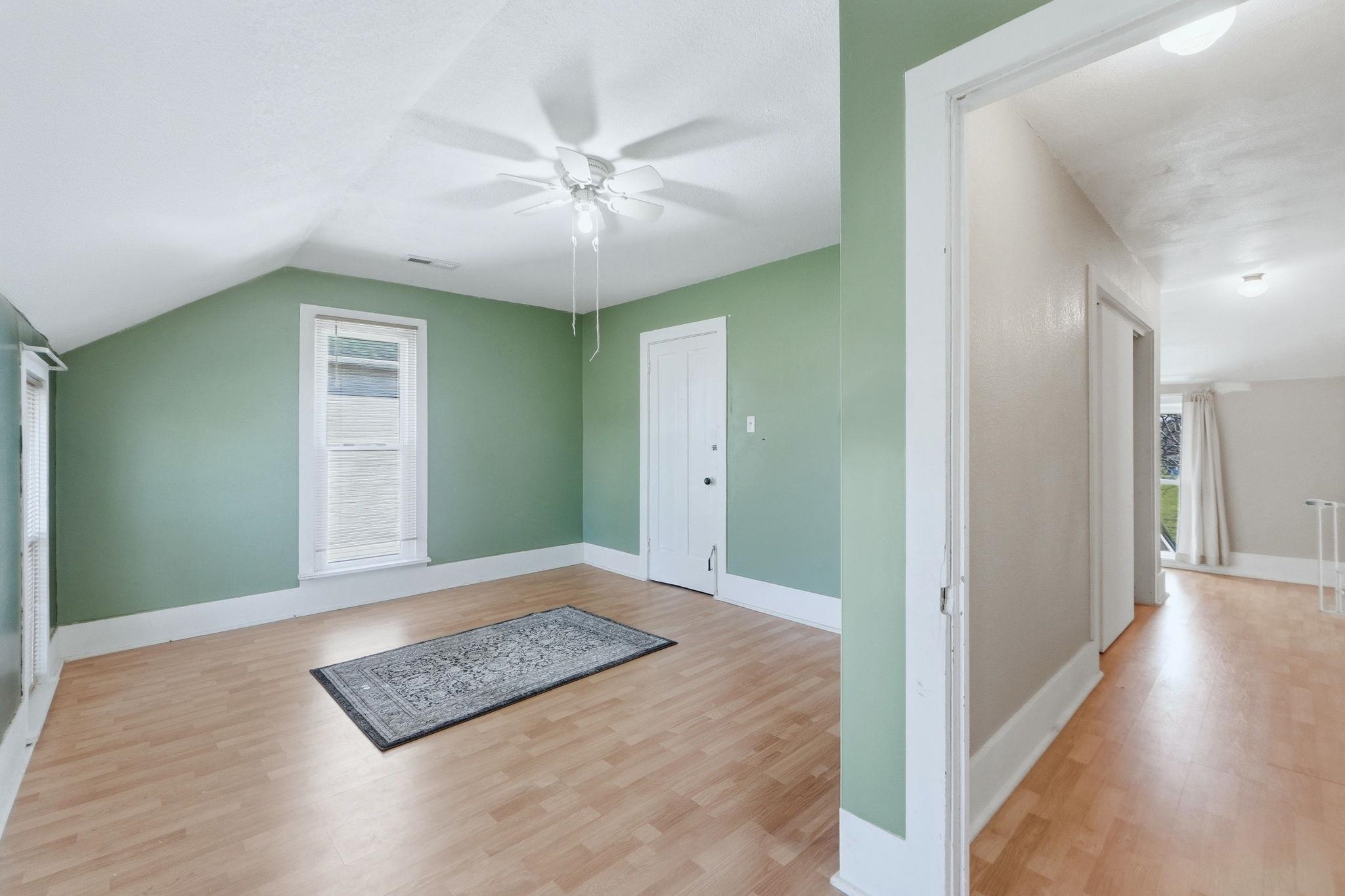 Bonus room with ceiling fan and light wood-style floors