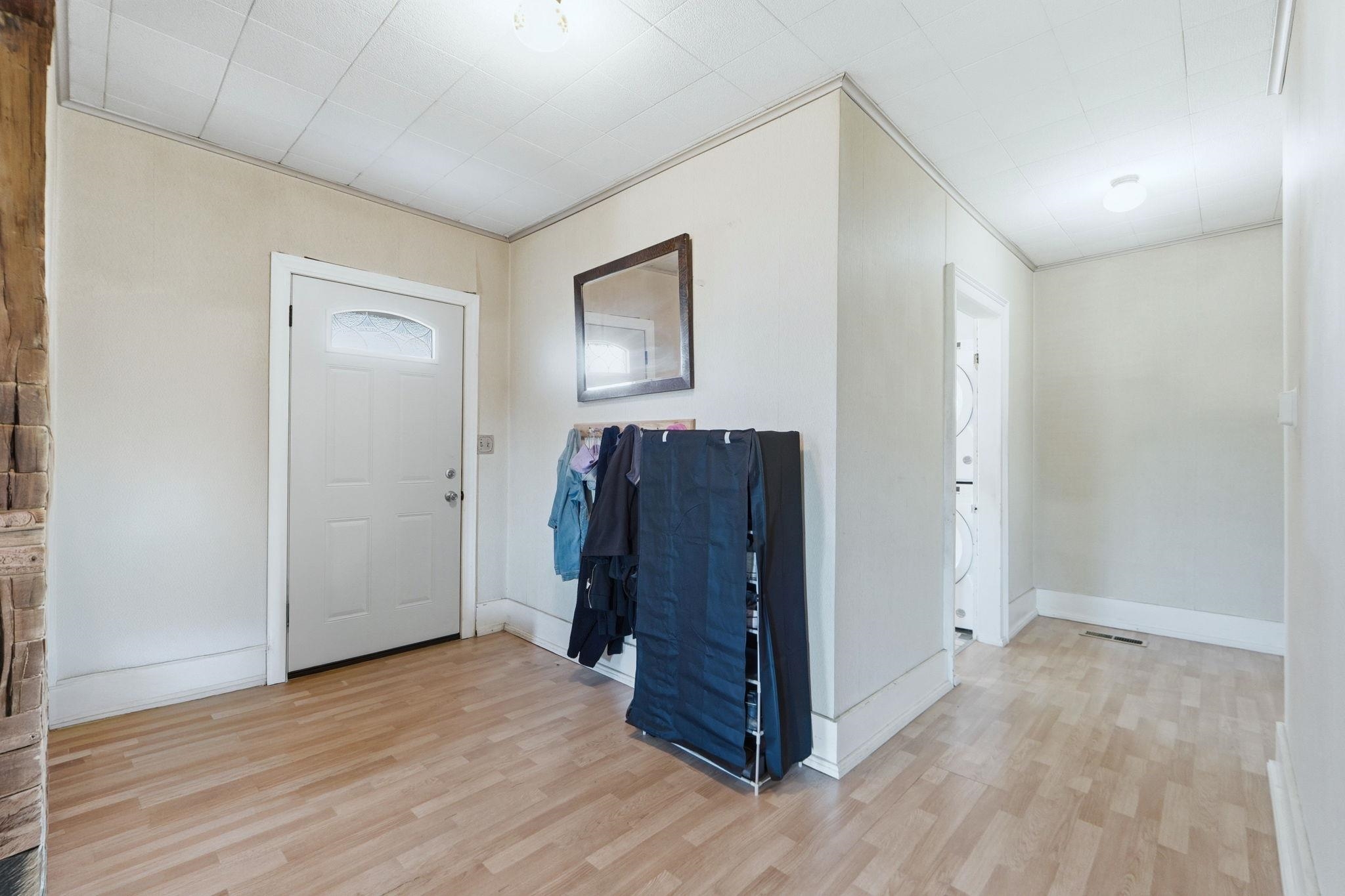 Entrance foyer with light wood-style floors and baseboards