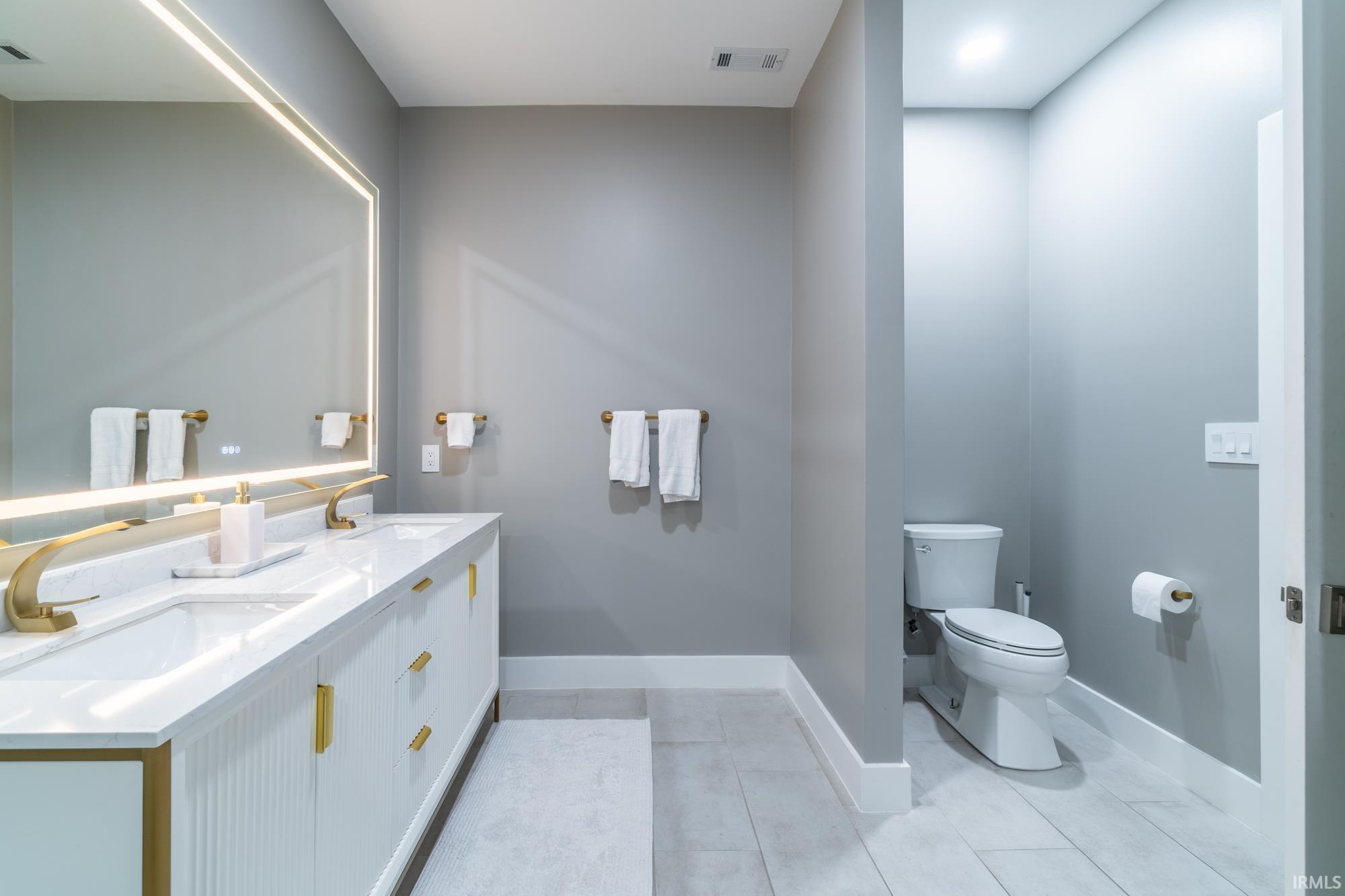 Bathroom with toilet and double vanity